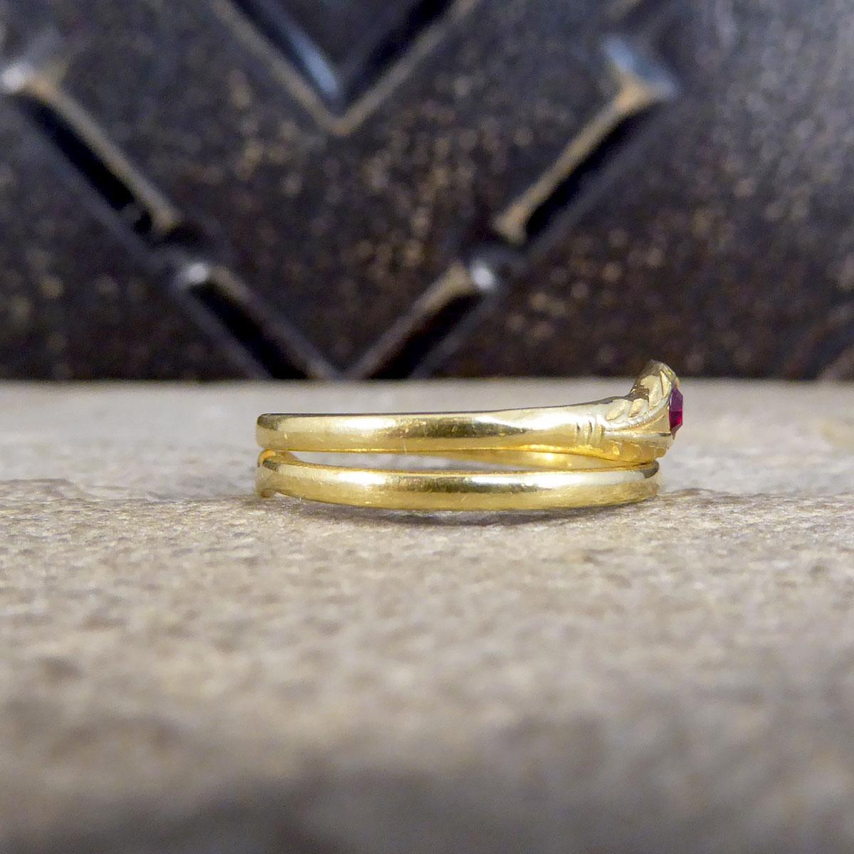 This vintage ring has been fully crafted from 18ct Yellow Gold and has been formed to resemble a snake wrapping around the finger. The snake has a shapely tale and detailed head set with a Garnet. Such a lovely little vintage serpent ring. This ring