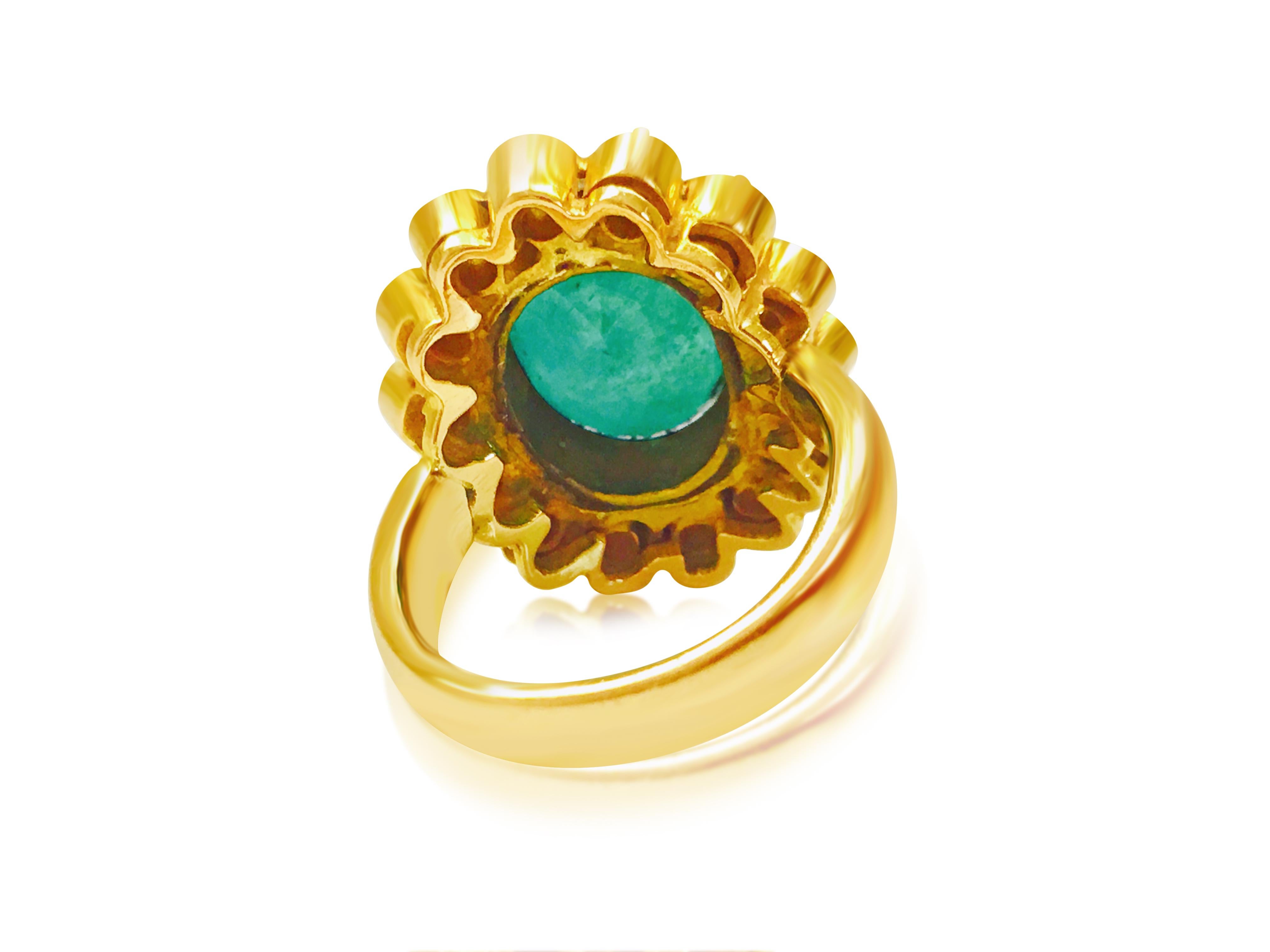 Indulge in luxurious elegance with this vintage ring, expertly crafted from 18K yellow gold. At its center gleams a magnificent 5.50-carat oval-cut natural emerald, held securely in place by delicate prongs. Encircling the emerald are dazzling