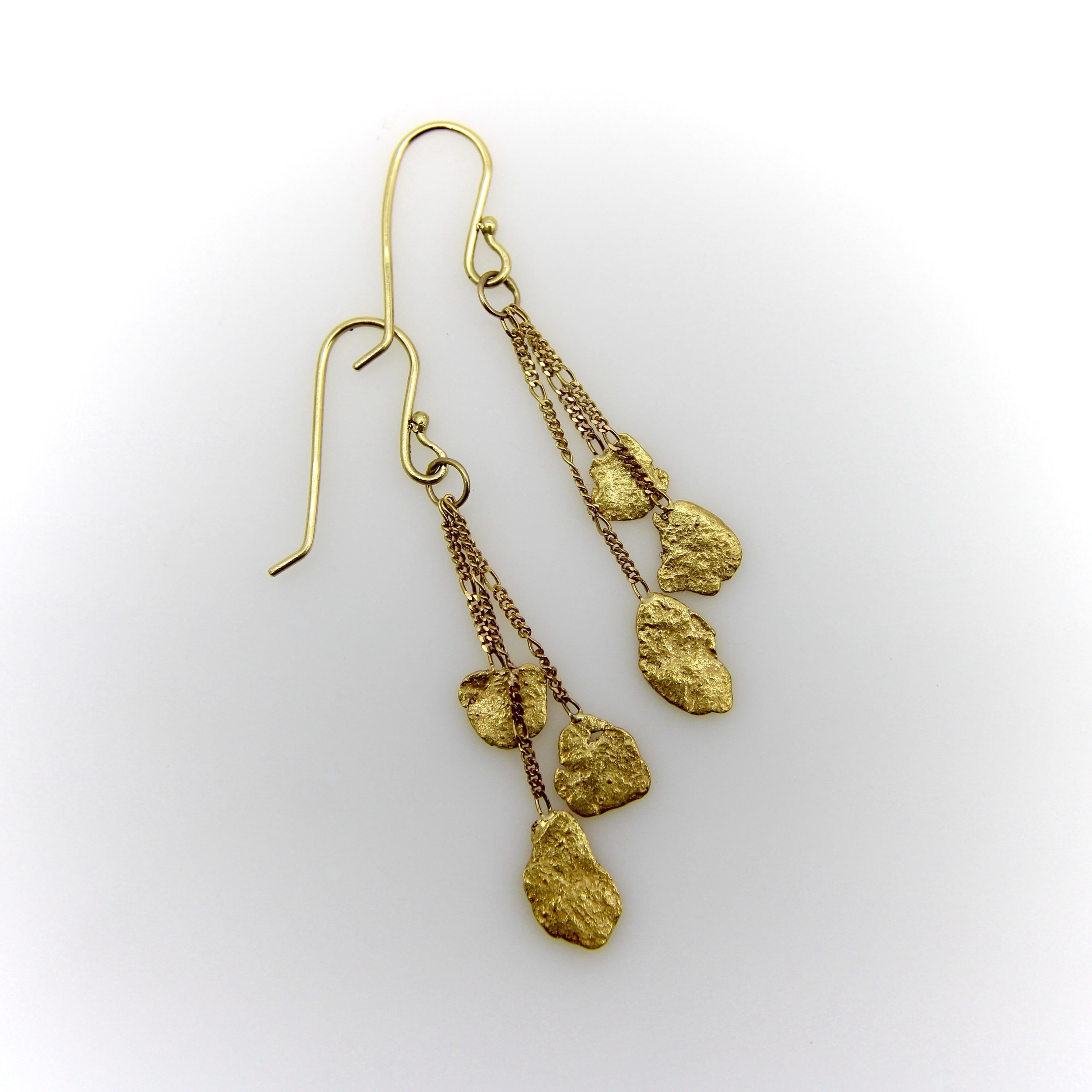 We love gold nuggets and search them out. We are always happy to find interesting variations on this theme and found these dangling gold nugget earrings to be especially charming. Three well-matched flat gold nuggets are suspended from three chains
