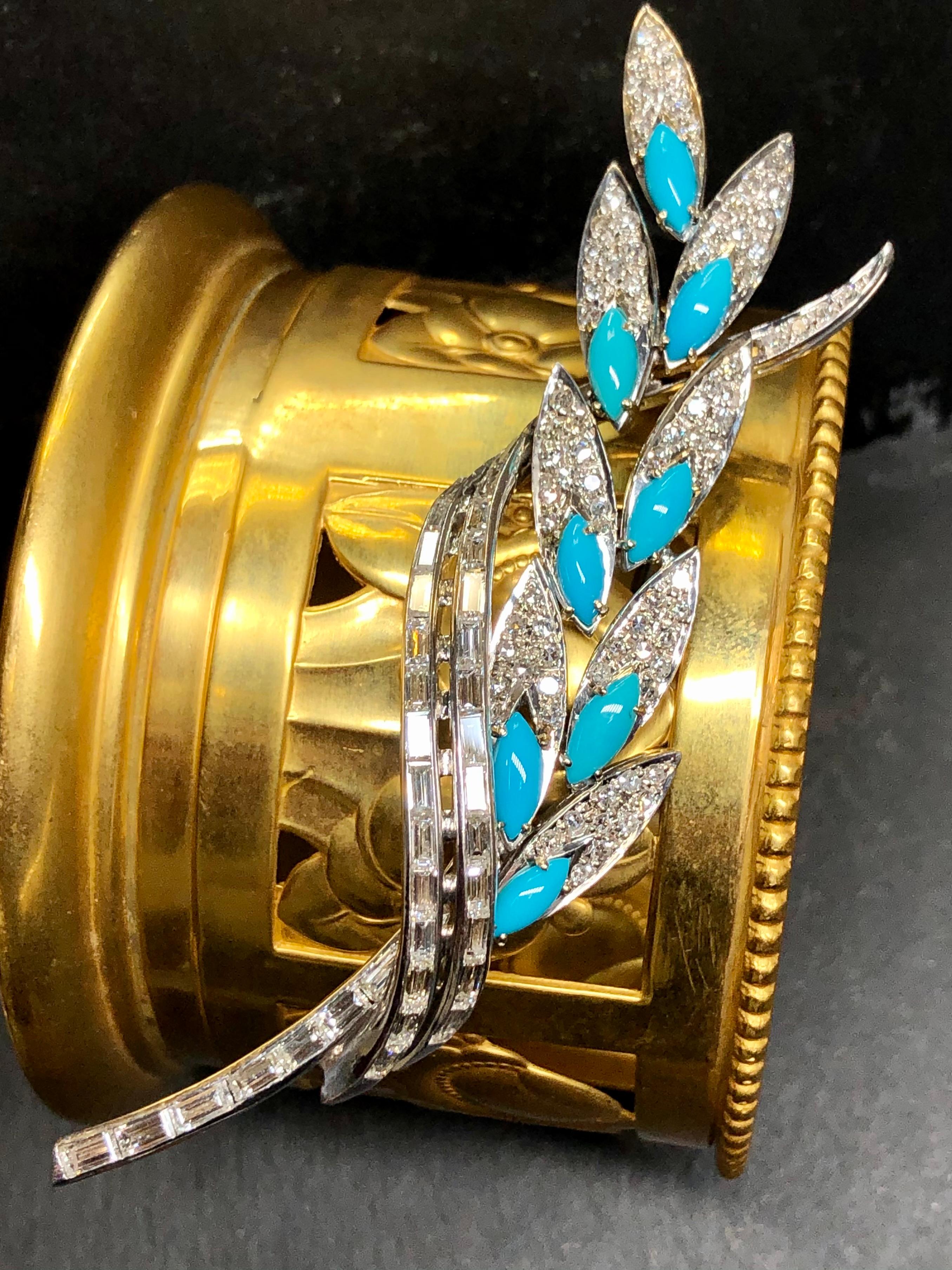 A stunner of a brooch c. 1950’s hand done in 18K white gold set with approximately 4.68cttw in baguettes as well as 1.68cttw in round cut diamonds and all stones are an impressive G-H color and Vs1 clarity. Each leaf is also prong set with natural