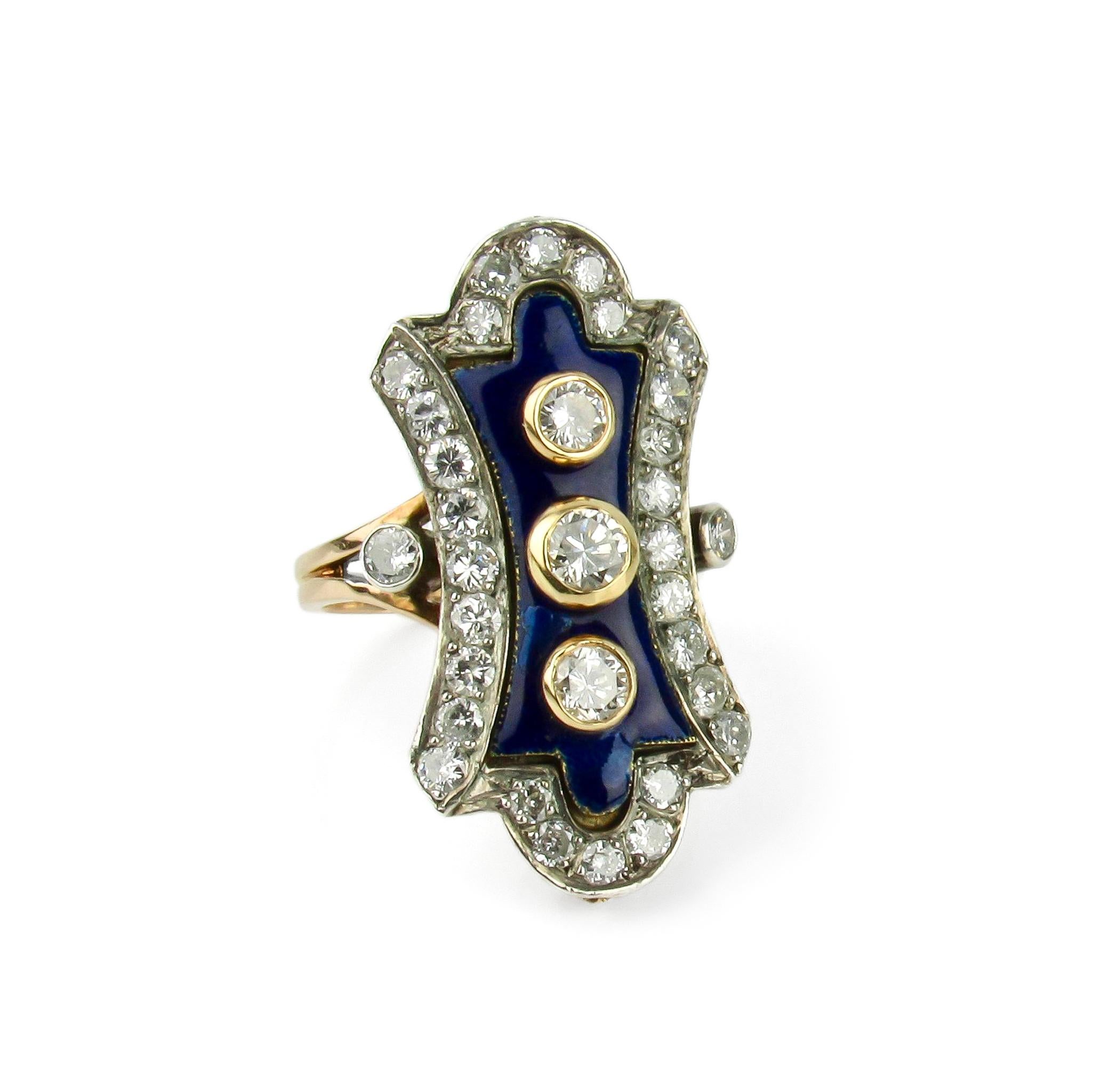 An elegant elongated lobe-shaped ladies ring crafted in silver topped 18 karat gold featuring a center panel of blue enamel with bezel set round brilliant diamonds, surrounded by a border of round brilliant diamonds. 

Measurements: 1 1/4