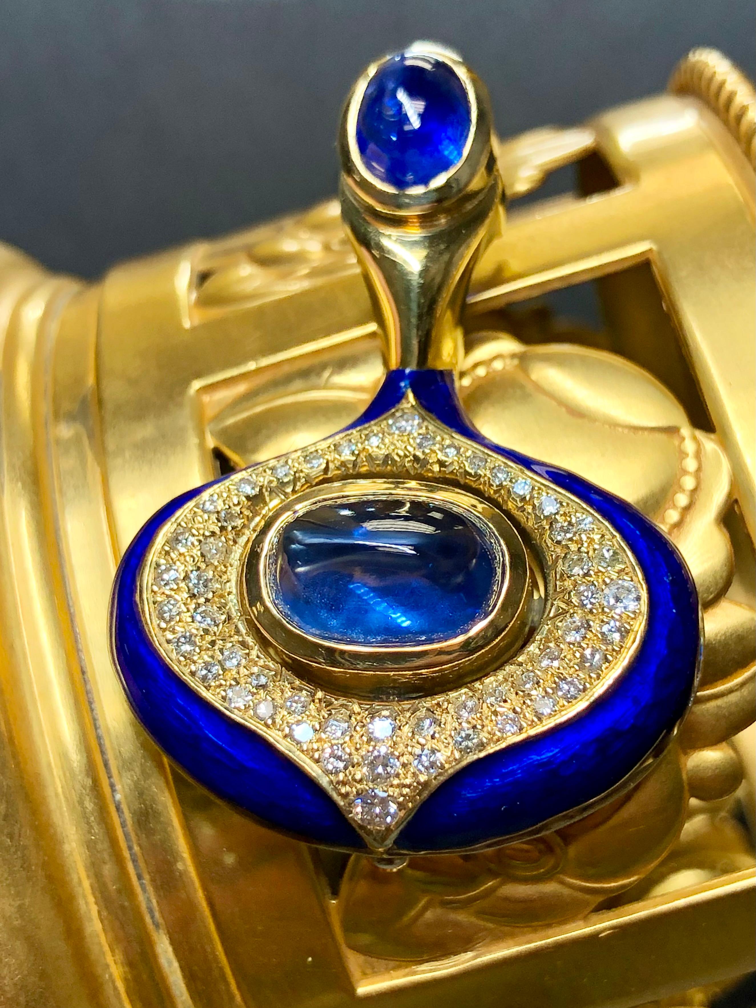 
A one-of-a-kind and most likely commissioned. It is hand wrought in 18K yellow gold and finished in royal blue enamel with both the top and bottom sections centered by large cabochon sapphires with the largest being a sugarloaf. The top sapphire