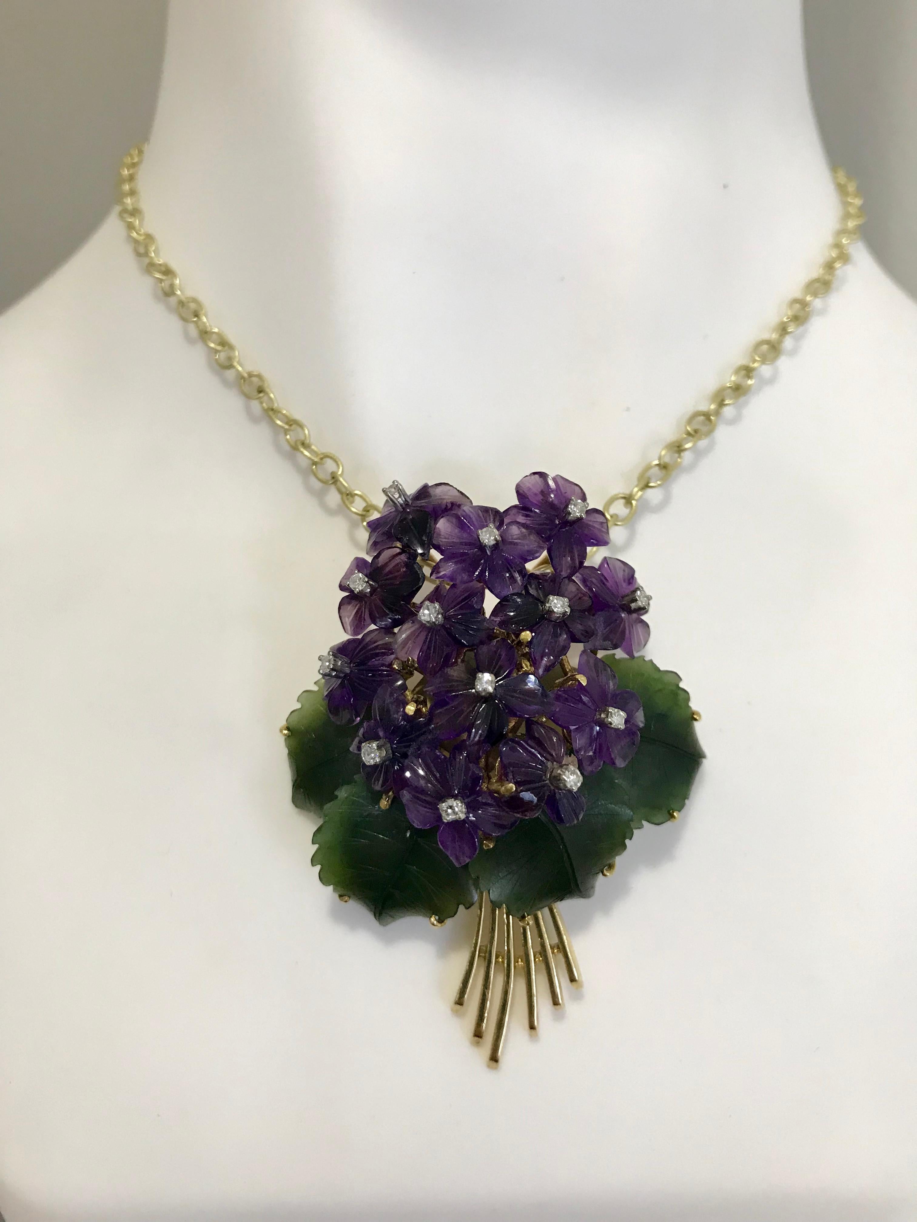 Vintage 18k yellow gold Diamond, Amethyst, Nephrite Jade Flower Brooch/Pendant.   

Vintage carved Nephrite leaves surround a beautiful bouquet of Amethyst African violet flowers each featuring a sparkling diamond.  Superior craftsmanship and