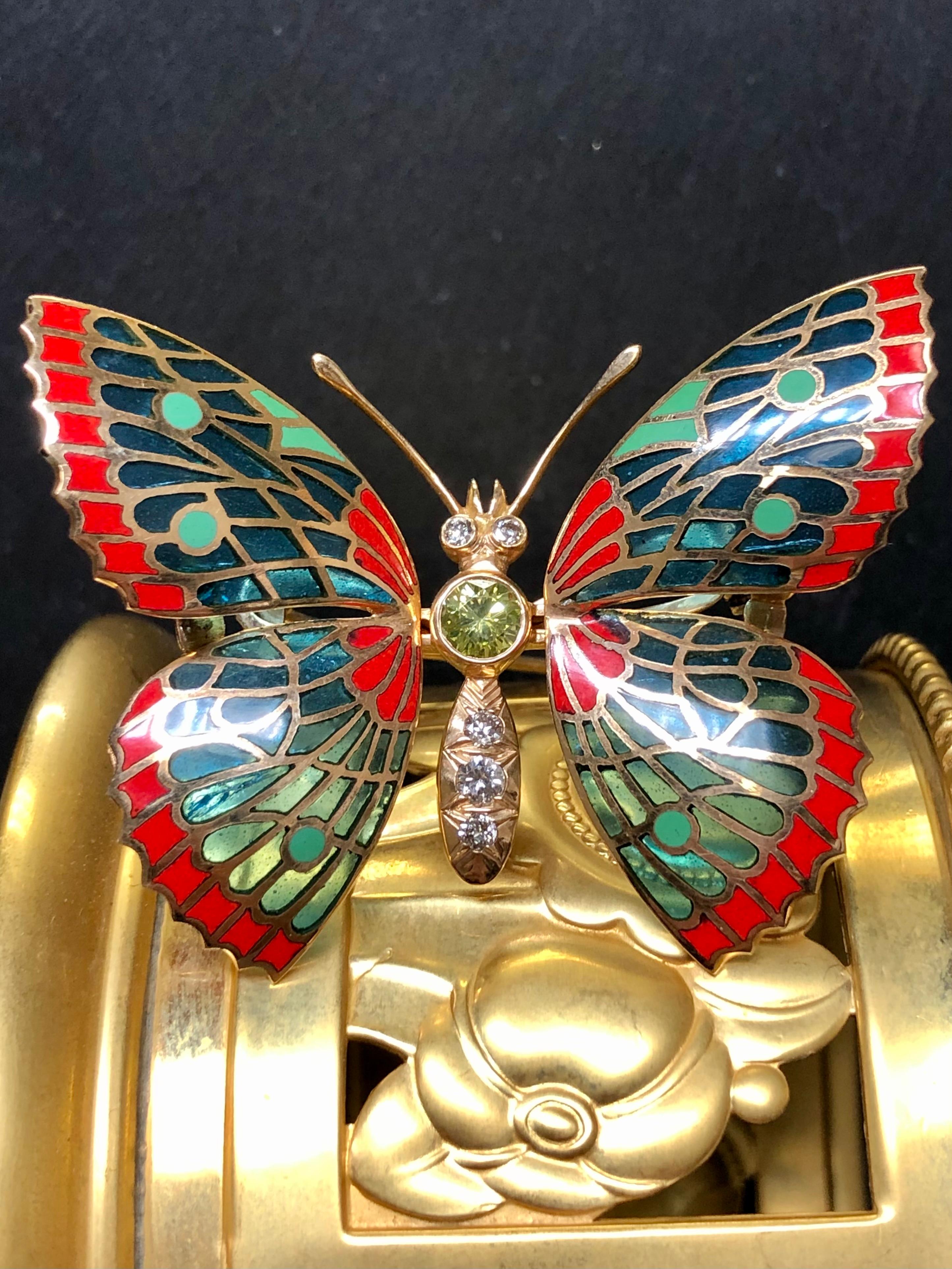 A beautiful example of well done plique-ajour enamel. This beautifully crafted piece has been done in 18K yellow gold and centered with an approximately .50ct fancy yellowish green Vs clarity diamond (likely treated) as well as another approximately
