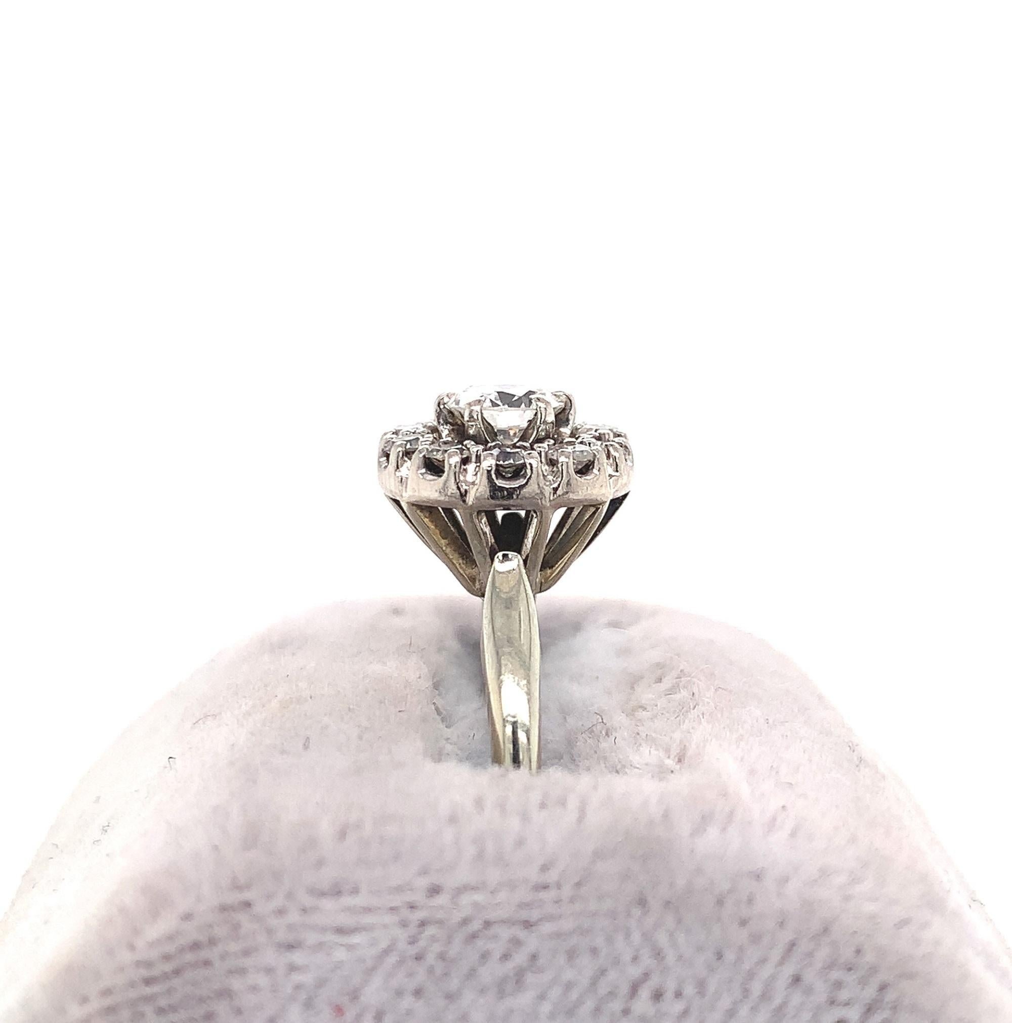  18k white gold antique diamond ring with about .60 carats total weight of vintage round diamonds. The center diamond measures about 4.7mm and weighs about .44cts. The 10 surrounding single cut diamonds measure about 1.7mm each. The diamonds have H