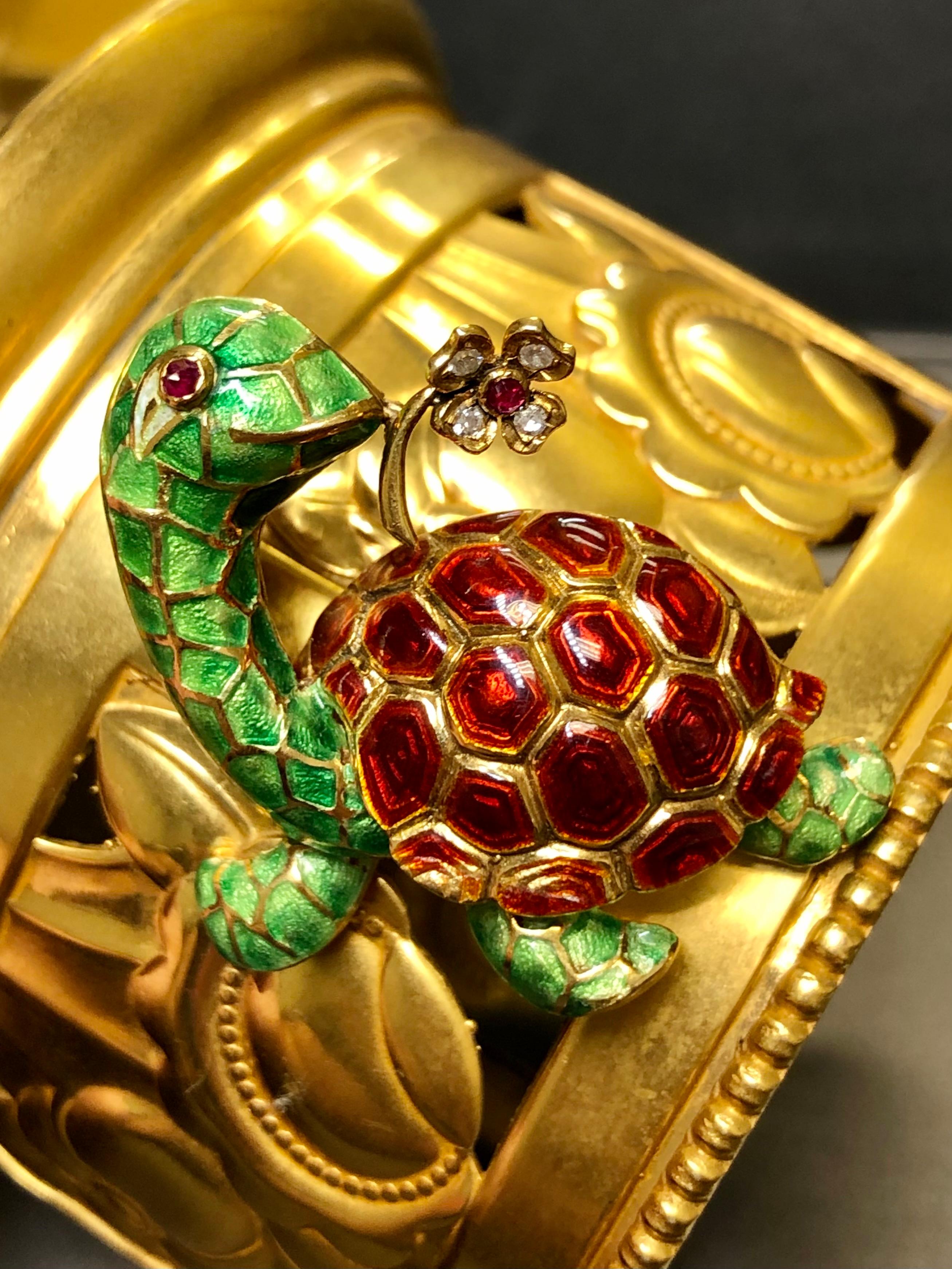 Such a pretty pin and the colors are gorgeous! Done in 18K yellow gold, this whimsical turtle brooch has been set with approximately .06cttw in G-H Vs diamonds as well as a centerl natural ruby. The best part is that the flower is en