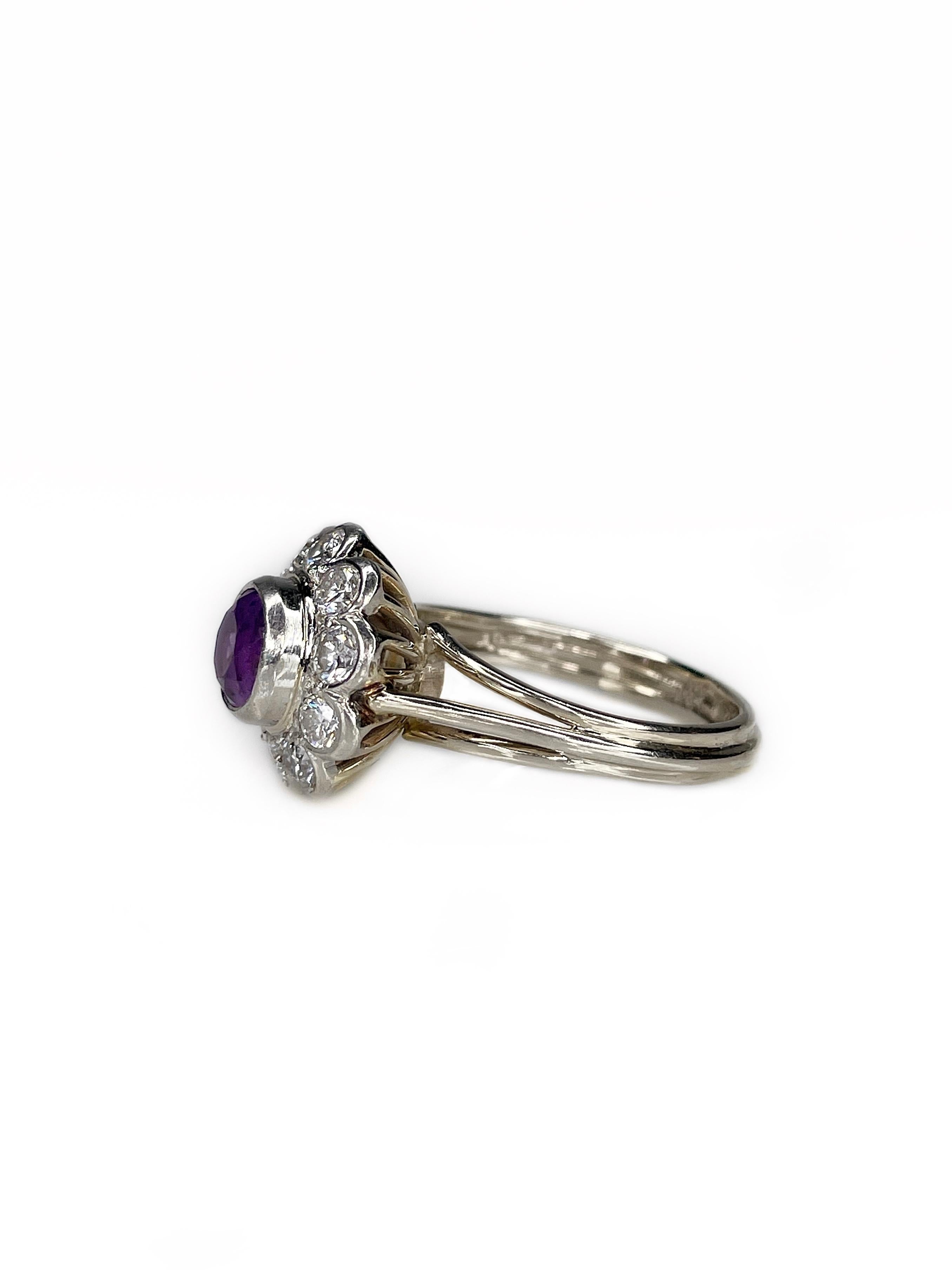 This is a classic design cluster ring crafted in 18K gold. Central stone is 0.70ct round single cut amethyst (diameter 0.6cm, P6/3, SI). It is surrounded by 10 round brilliant cut diamonds, which weight in total 0.70ct, colour is RW/W, clarity