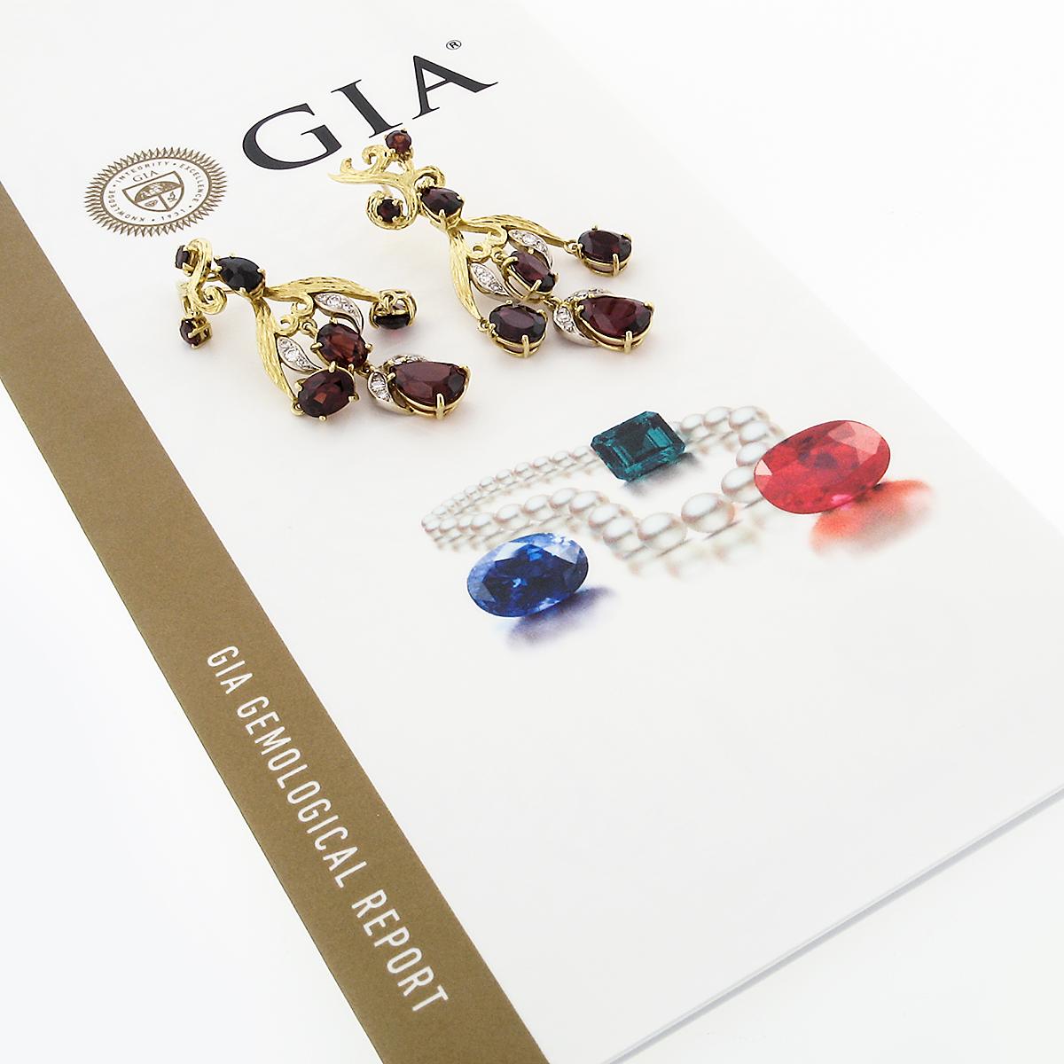 This gorgeous pair of pyrope garnet and diamond earrings was crafted from solid 18k yellow and white gold. These earrings features a pair of beautiful, prong set, pear modified brilliant cut pyrope garnets that has been certified by GIA. The 2