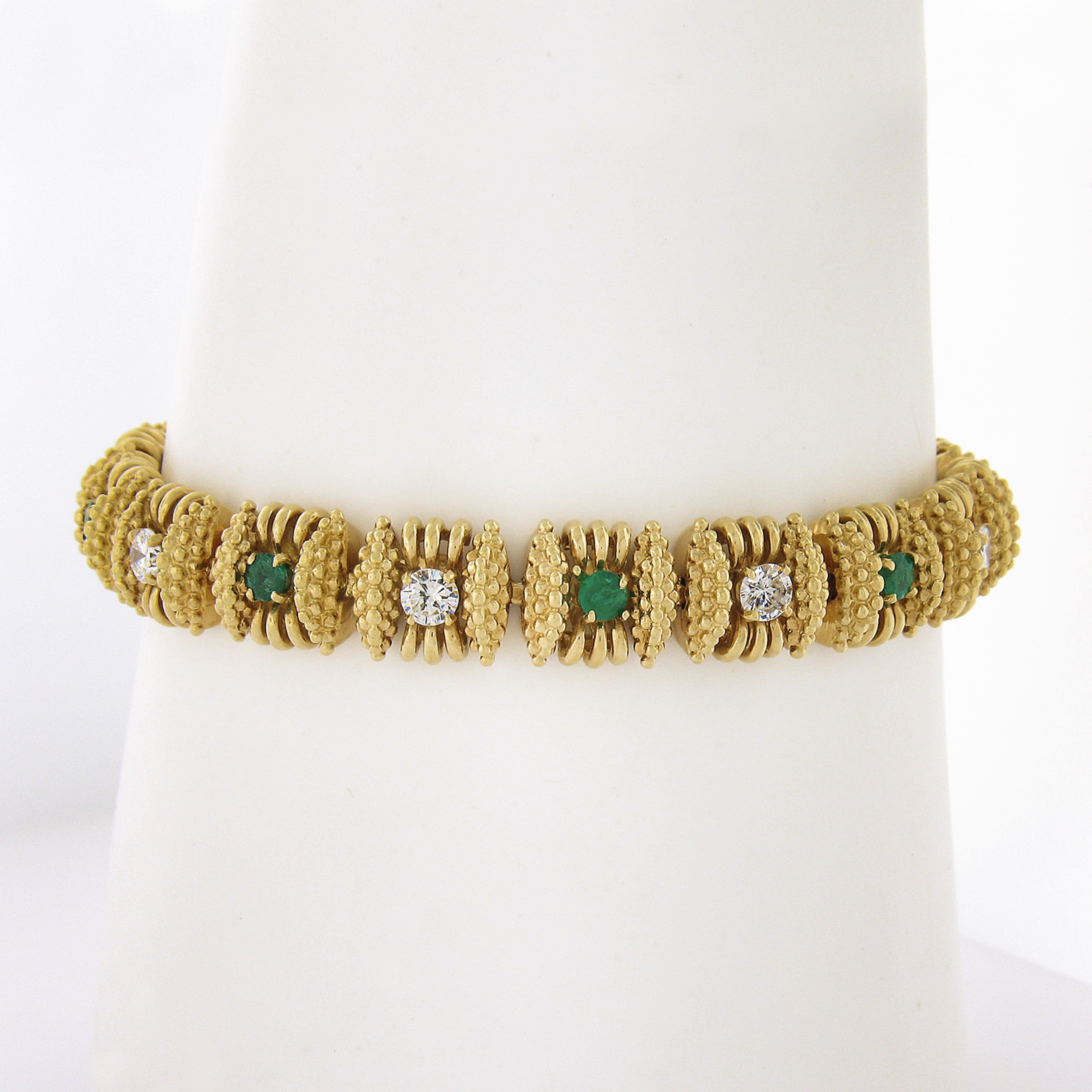 This magnificent vintage statement line bracelet is very well crafted from solid 18k yellow gold. It features top quality emeralds and large diamonds neatly prong set throughout. This is an outstanding and very well made bracelet that is absolutely