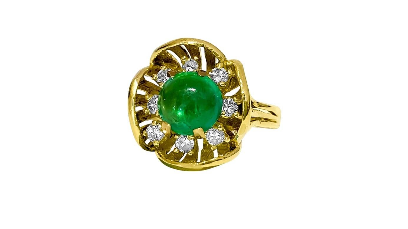 Crafted in 18K yellow gold, this vintage ring features a stunning 2.50 carat Colombian emerald in a cabochon cut, exuding timeless elegance. Adorned with 0.40 carats of G color diamonds with VS clarity, each stone is 100% natural earth mined and set