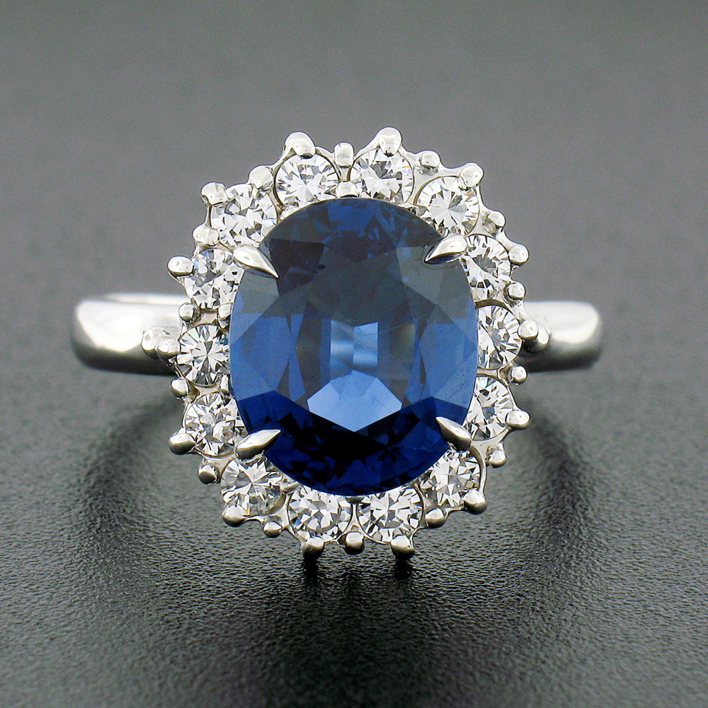 This absolutely stunning vintage ring is crafted from solid 18k white gold and features a magnificent, GIA certified, natural sapphire stone neatly prong set at its center. This large and very clean sapphire is a top shelf stone and has the most