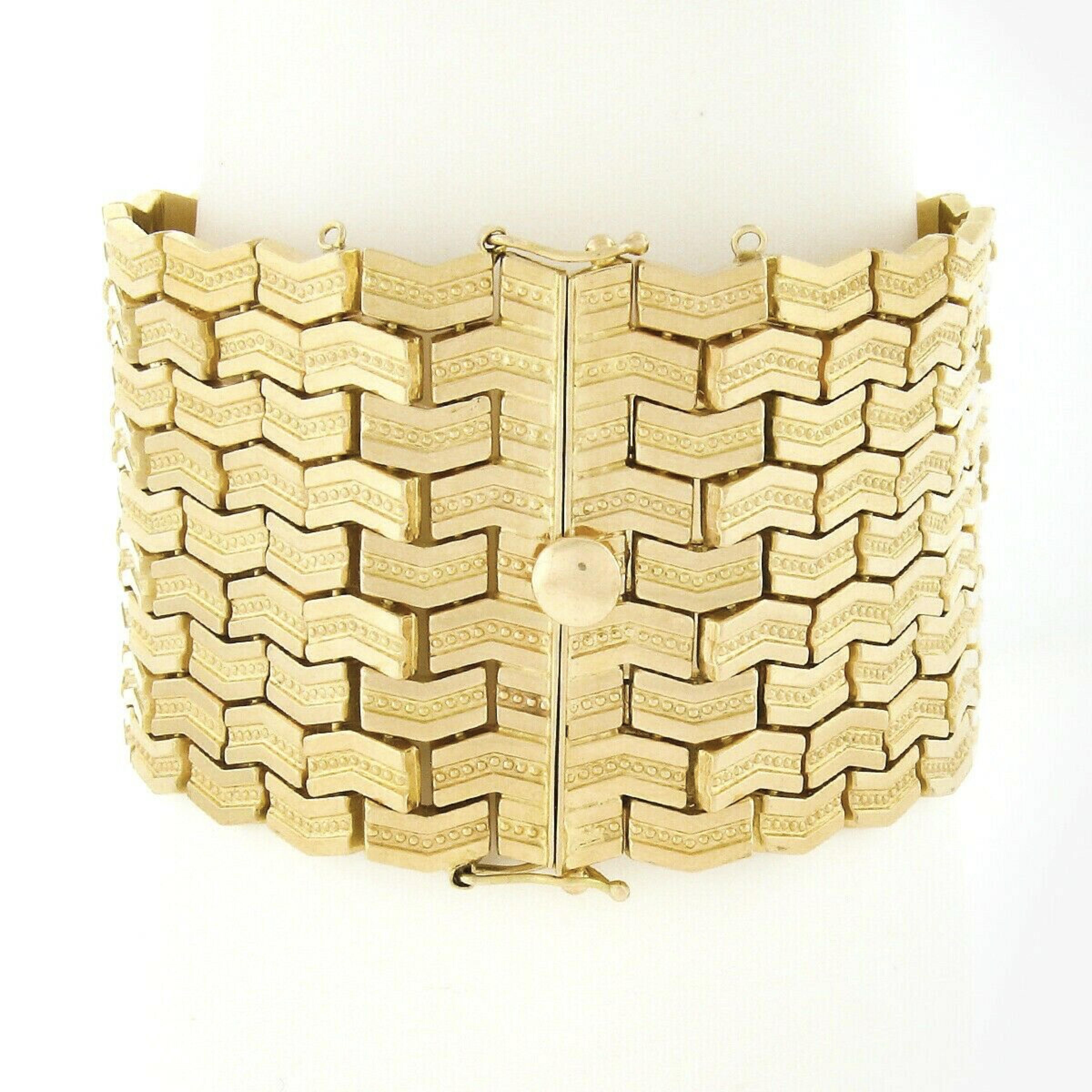 This magnificent vintage strap bracelet was crafted from solid 18k yellow gold and features a wide design constructed from 9 rows of geometric shaped links neatly set throughout. Each link has a nice high-polished finish with elegant bead work