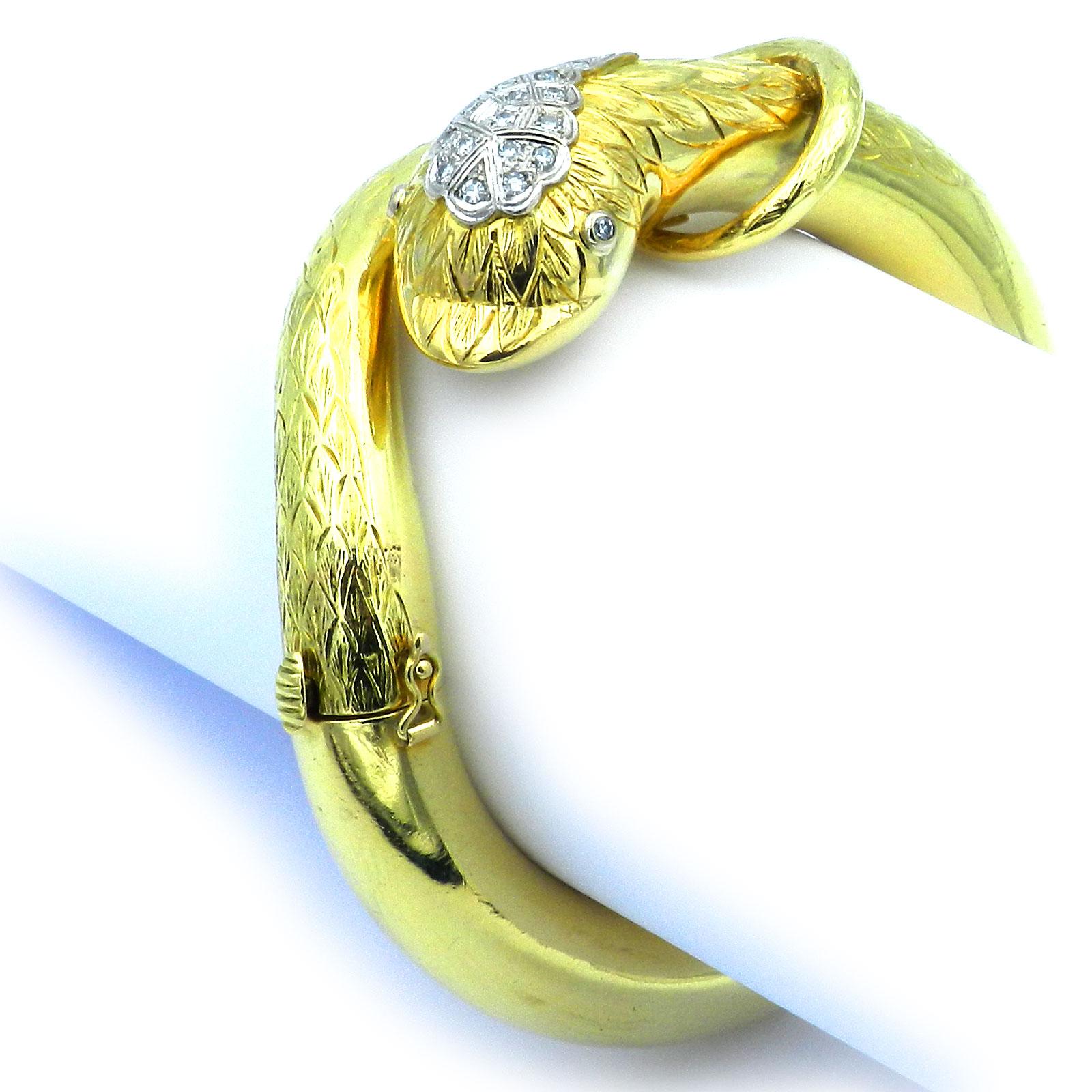 Vintage 18K Gold and 0.29 ct Diamond Snake Bangle Bracelet

Very decorative and unusual snake bangle with hinge in heavy workmanship, the top finely chased, the head and the eyes set with a total of 16 diamonds totaling 0.29 ct H/si, set in white