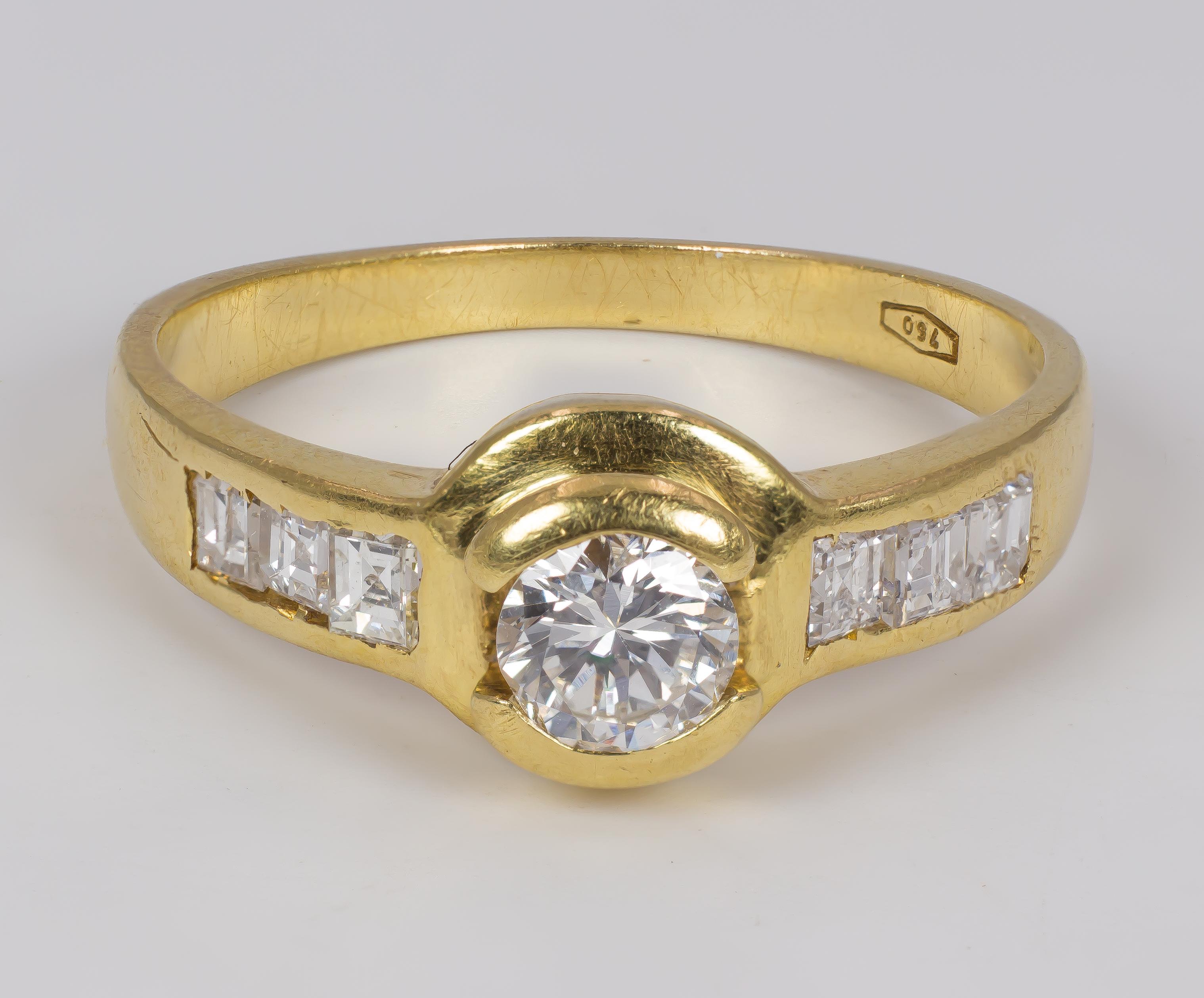 A fine vintage gold and diamond ring, dating from the 1960s. 
The head is set with a central 0.30ct round cut diamond, while the shoulders feature three baguette cut diamonds each one. 

MATERIALS
18K gold, one central round cut diamond (0.30ct) and