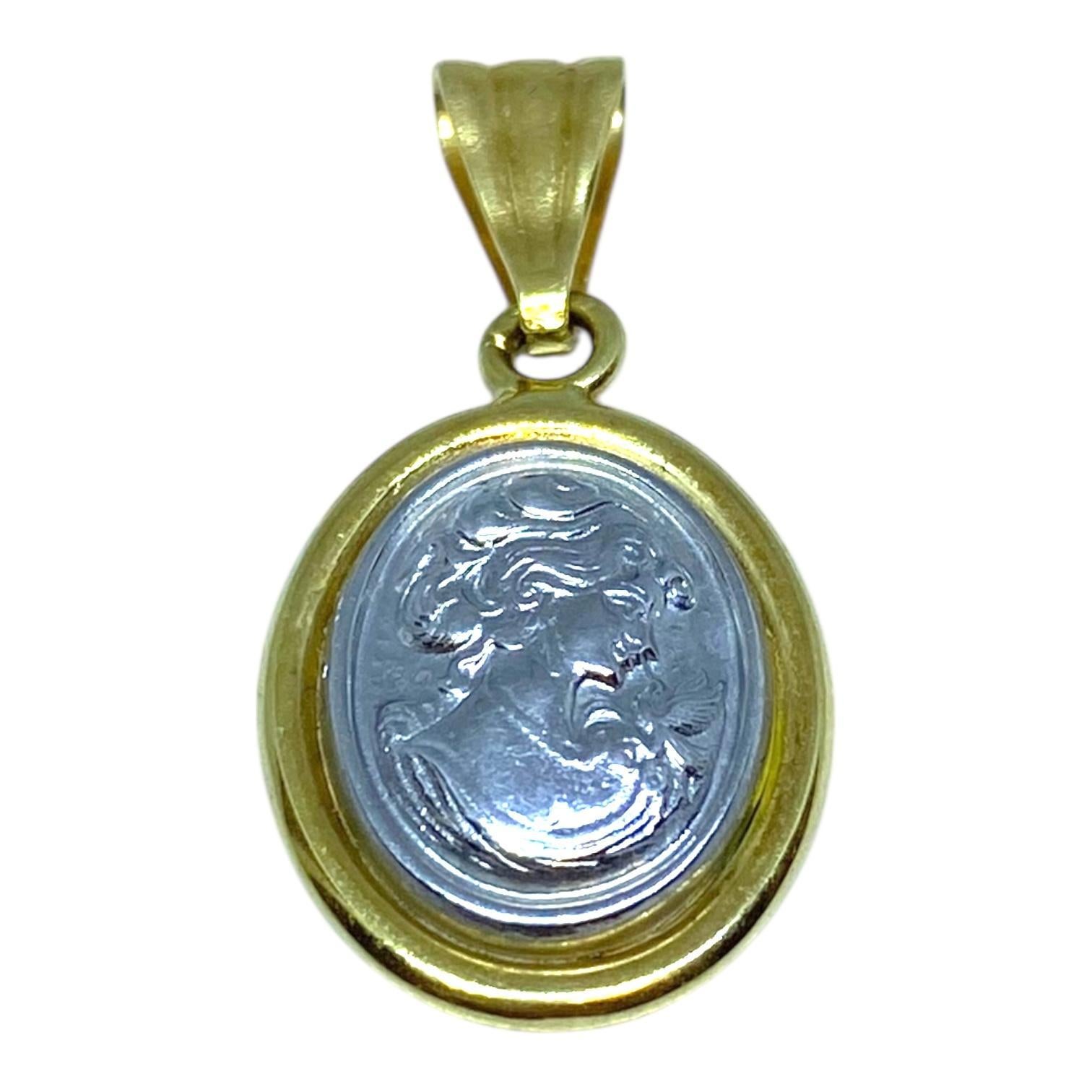 Crafted in 18K yellow gold and platinum, the pendant features an intricately detailed relief of a young female profile. The central platinum medallion is framed by a smooth, polished gold border, creating a striking contrast. The pendant's bail is