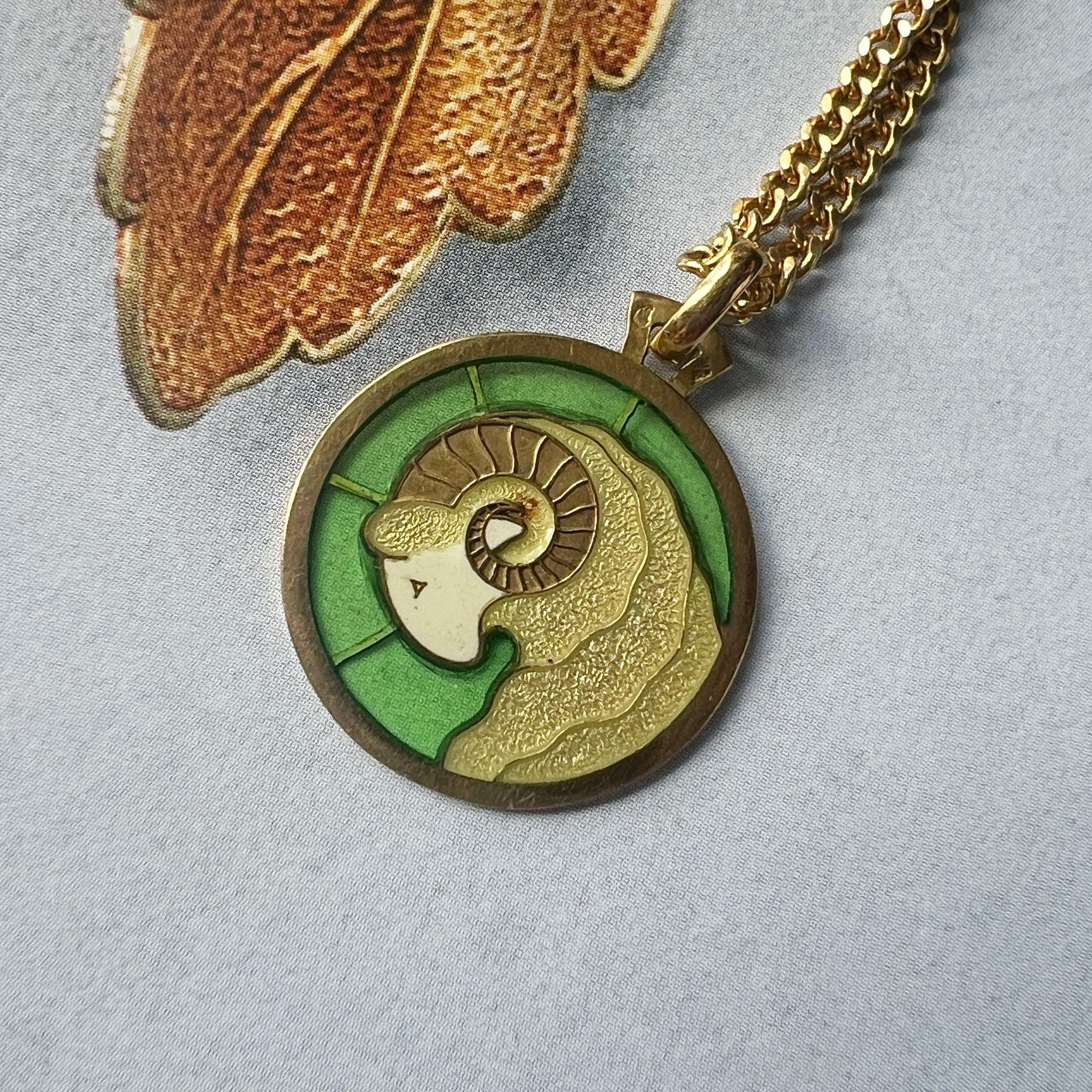 For sale a rare French Vintage 18K gold Aries Zodiac Medal by Maison Arthus Bertrand.

The medal features a beautiful green plique a jour enamel on which a ram head is shown, symbolising the Zodiac symbol of Aries. The lighter yellowish green color