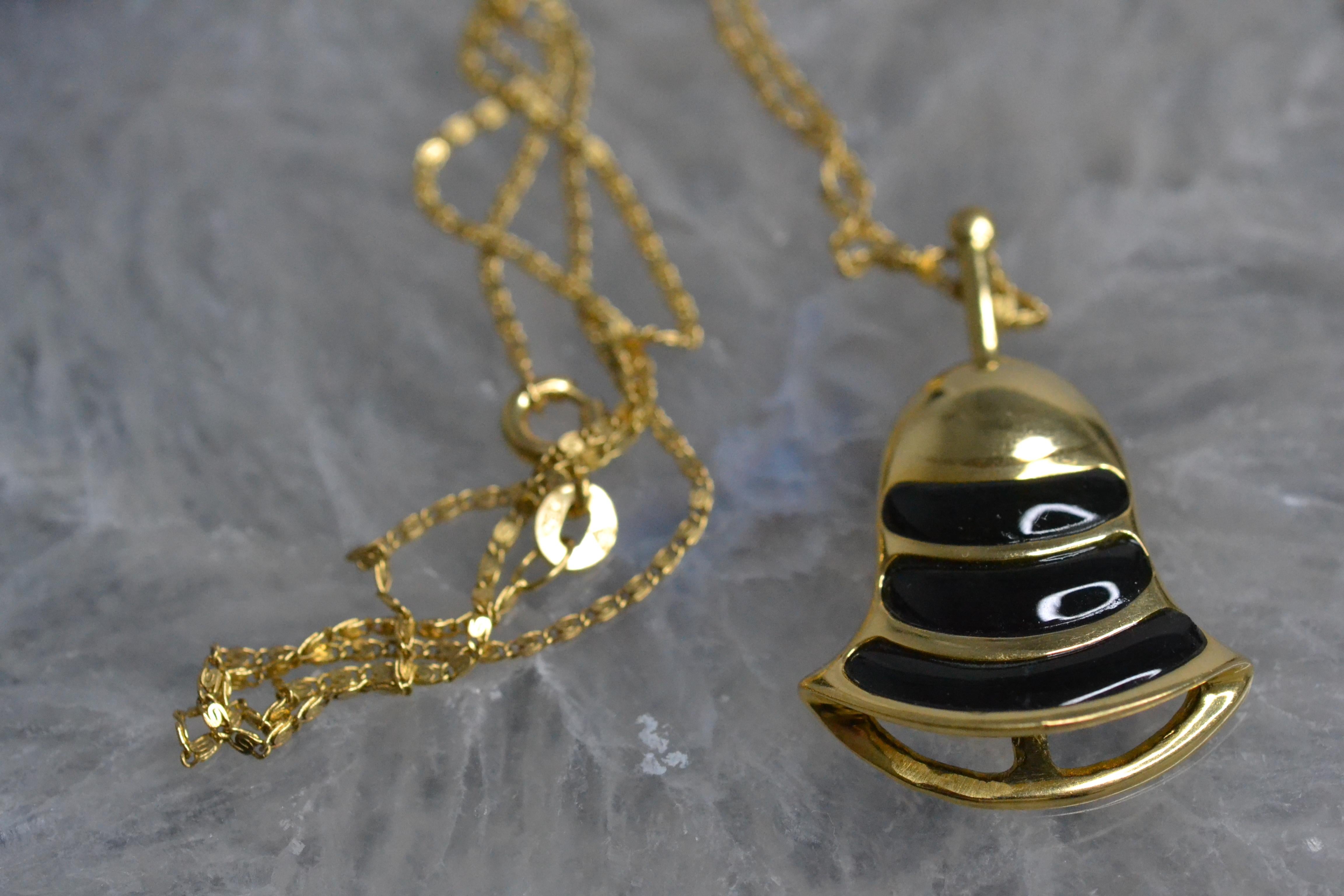 Vintage 18k Gold Bell Necklace with Onyx

These vintage bell necklaces are the perfect way to add a splash of colour to any outfit. Available in malachite, red jasper, tiger's eye and onyx, these limited edition necklaces from the 80s have a unique