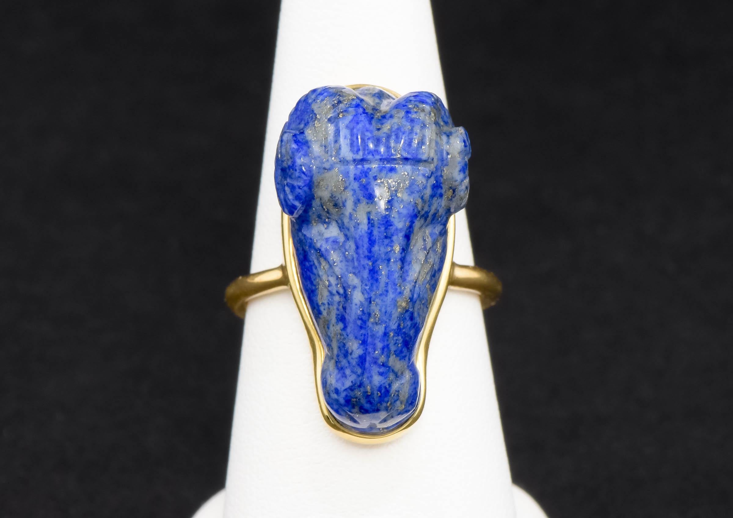 With a definite nod to the ancient use of the Ram's head for adornment, this striking vintage carved Lapis Lazuli and 18K gold ring makes a big, beautiful statement when worn.

Crafted of 18K yellow gold, the ring is set with a large and substantial