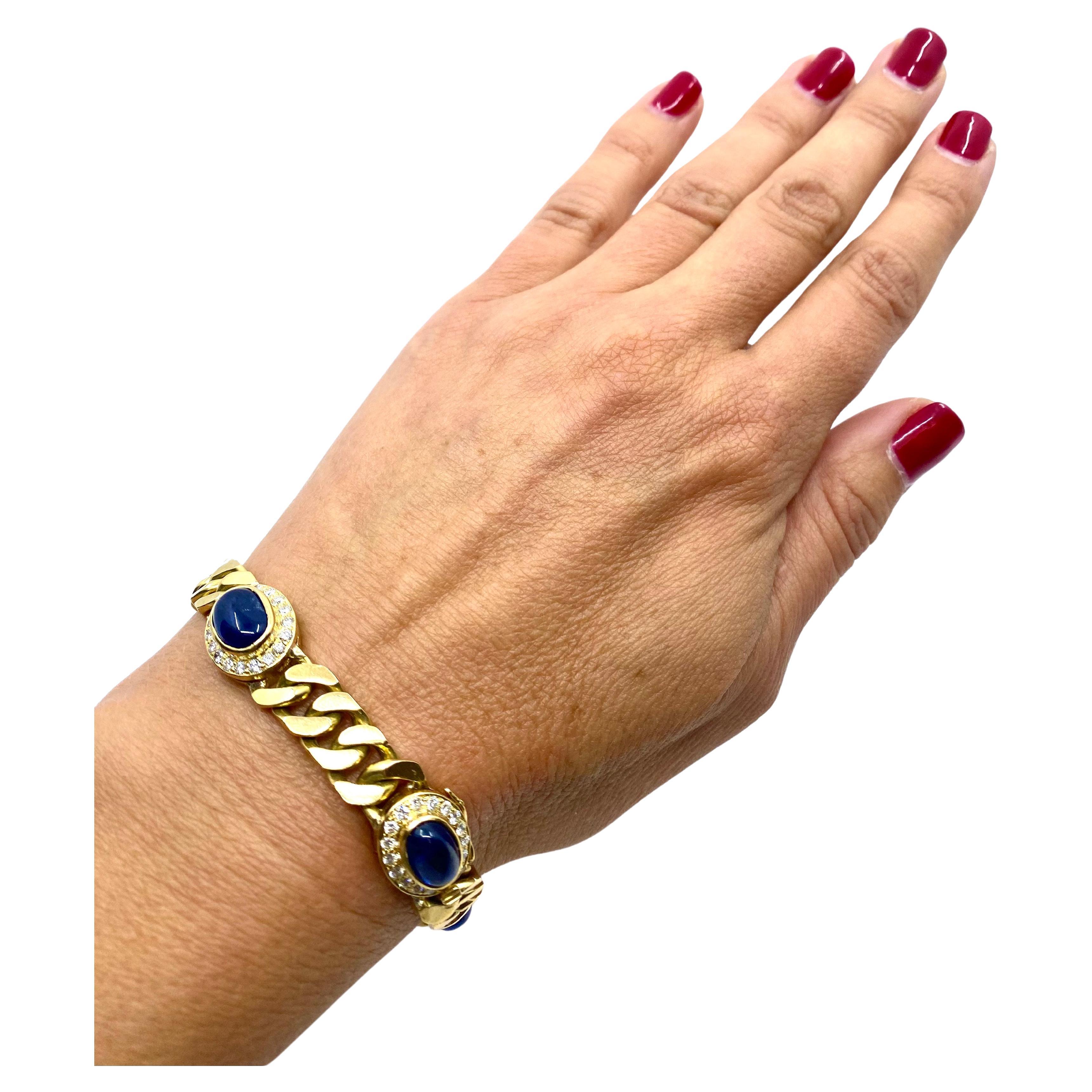 A classic vintage curblink chain bracelet made of 18k gold, features sapphire and diamond. The sapphires are cabochon cut, bezel set, five gems in total. The diamonds are round cut, set to beautifully frame the sapphires and underline their deep