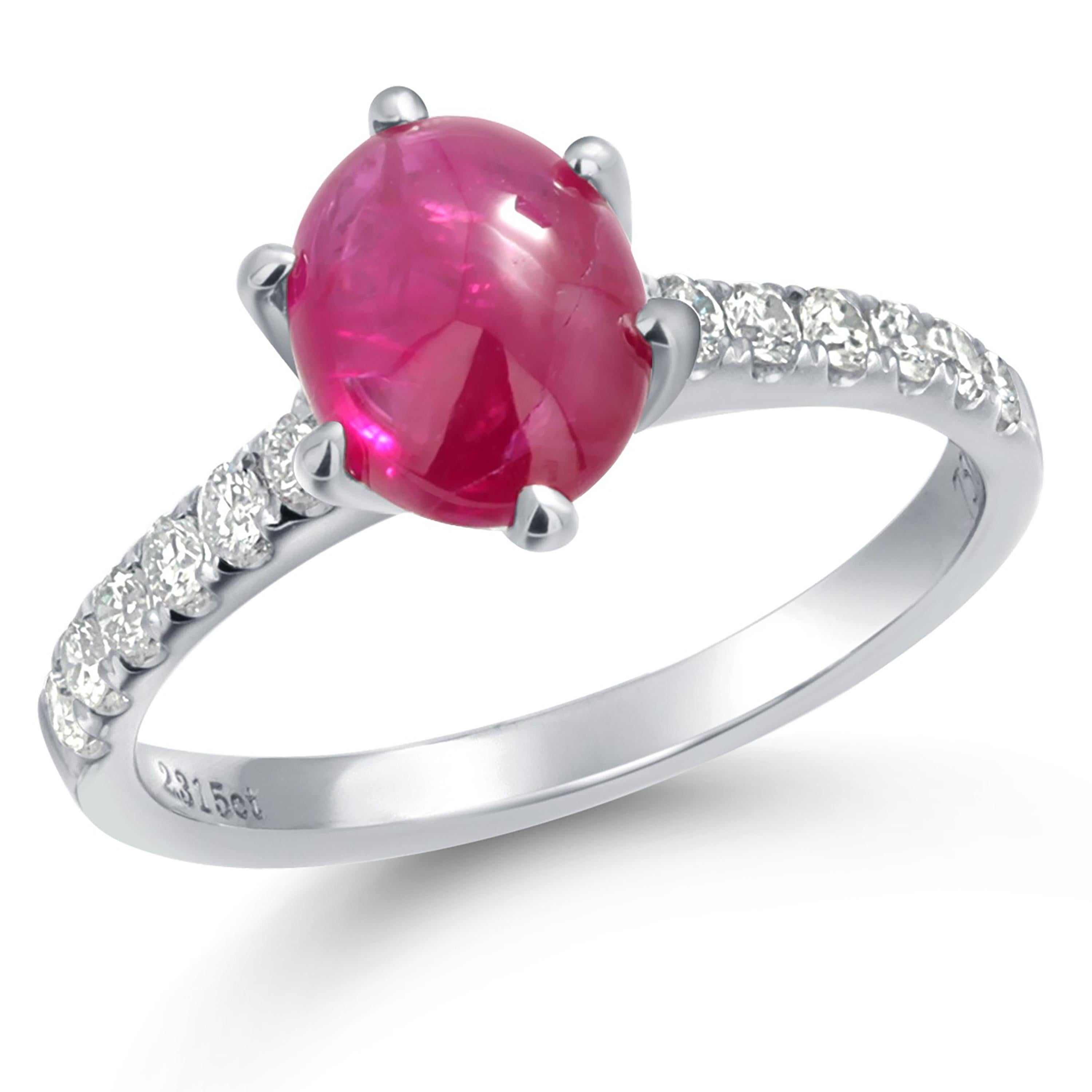 Immerse yourself in the timeless elegance of this vintage engagement ring, expertly crafted in luxurious 18 karat white gold. This exquisite piece features a fine quality Cushion Burma Cabochon Ruby, weighing an impressive 2.10 carats, nestled