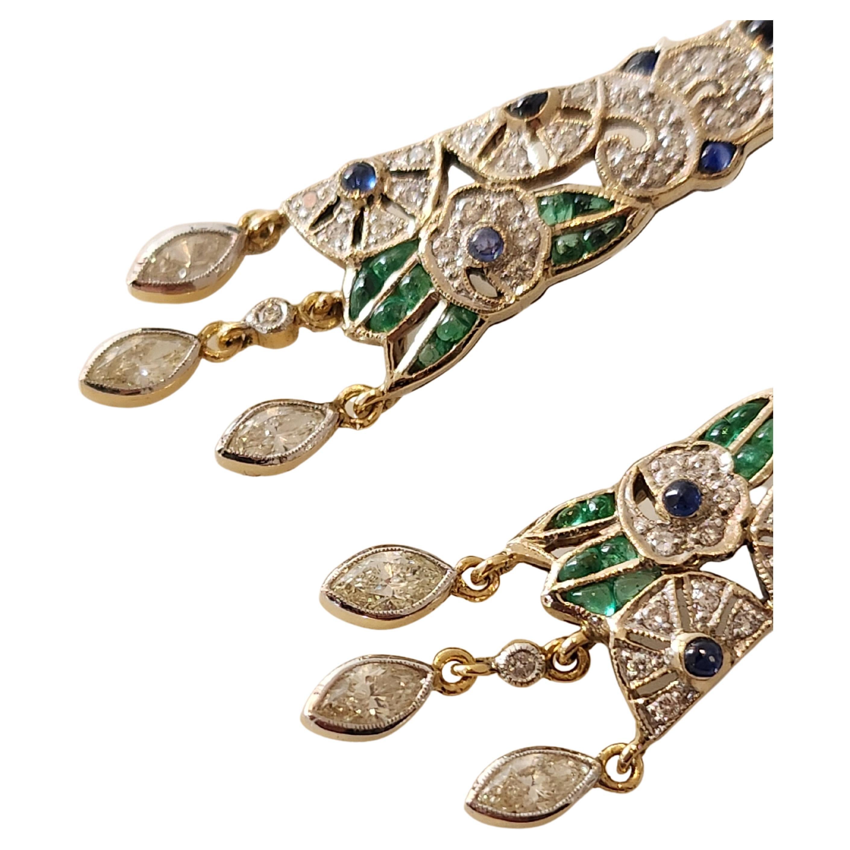 Art deco diamond earrings in 18k gold setting decorted with brilliant cut diamonds green emeralds and blue sapphire in geomatric and ornamental designe comprised of 6 navvet diamonds and 69 brilliant cut diamonds over all weight 1.20 carats and 24