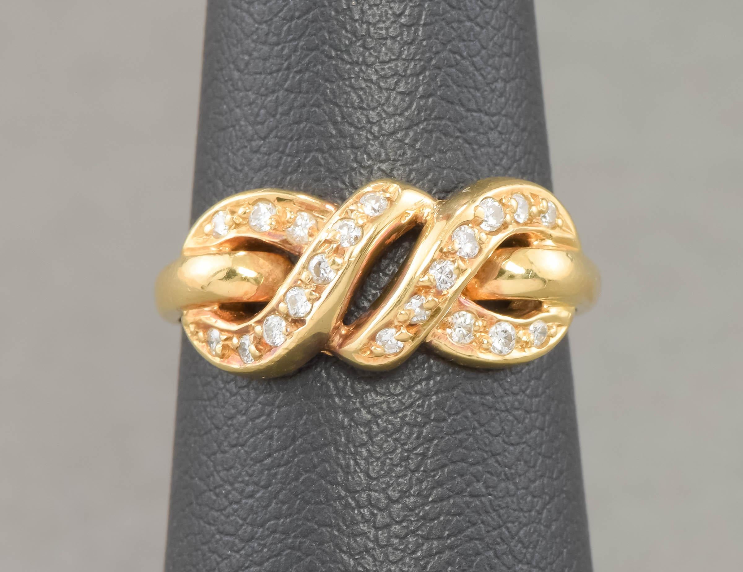 I’m pleased to offer a wonderful, classic & elegant diamond eternity love knot ring from the 1980's.

Crafted of solid 18K yellow gold, the ring features an eternity knot design, sparkling with 20 very clean and fiery modern round brilliant cut