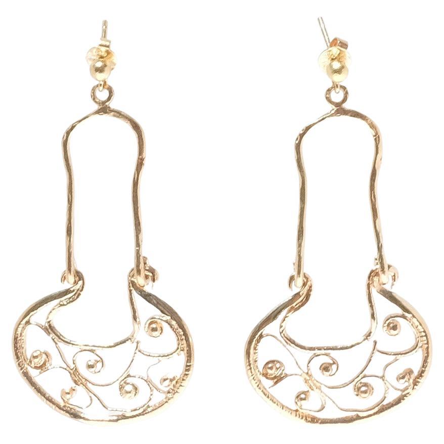 These 18 karat gold earrings have an oriental look with its simple, traditional shape and floral pattern. To keep the earrings in place a pole with a clutch backing is used. 

The earrings have a simple and elegant look and will work well at any