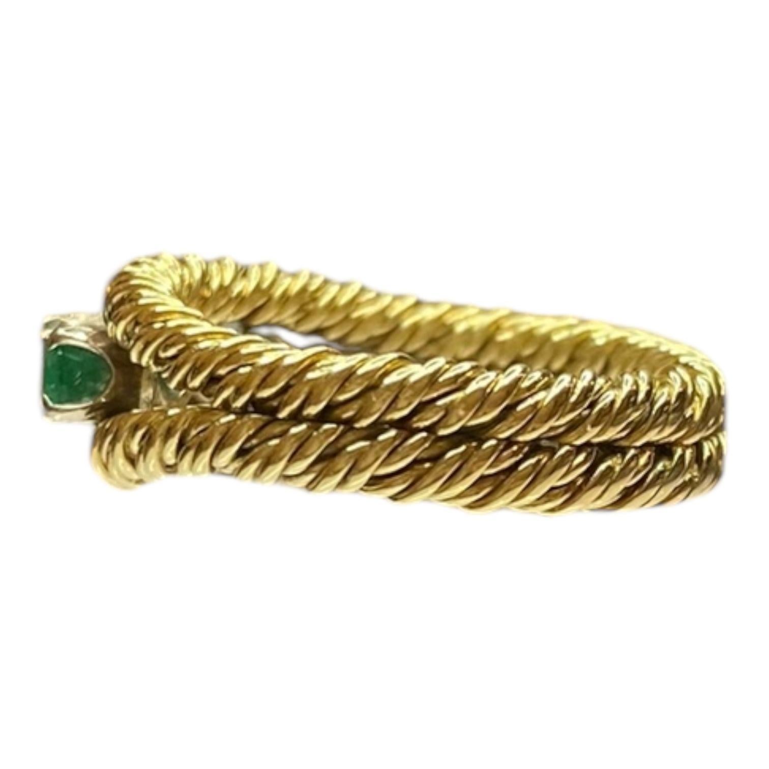 Vintage 18k yellow gold band ring featuring a twisted rope design. Set with alternating round green emeralds and brilliant white diamonds. 
3 Emeralds: approximately 0.3 ctw. 
2 Diamonds: 0.3 ctw. Clarity: VS2-SI1, Color: G-H. 
Measurements:
Width: