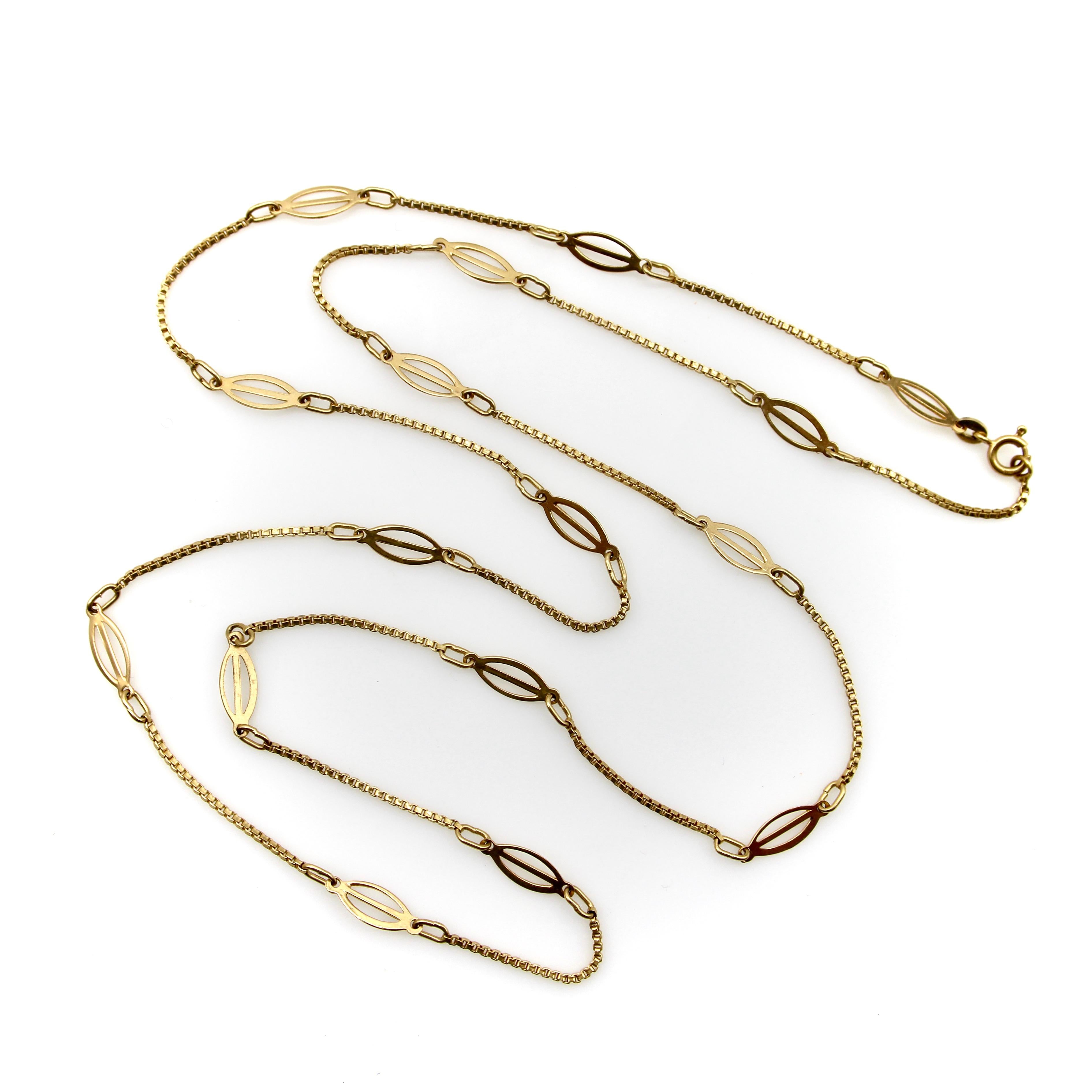 This 18k gold fancy link chain consists of elongated bisected oval links, sandwiched between sections of box link chain. The shape adds texture and reflects the light, making for a visually eye catching chain that is rhythmic is a way that is