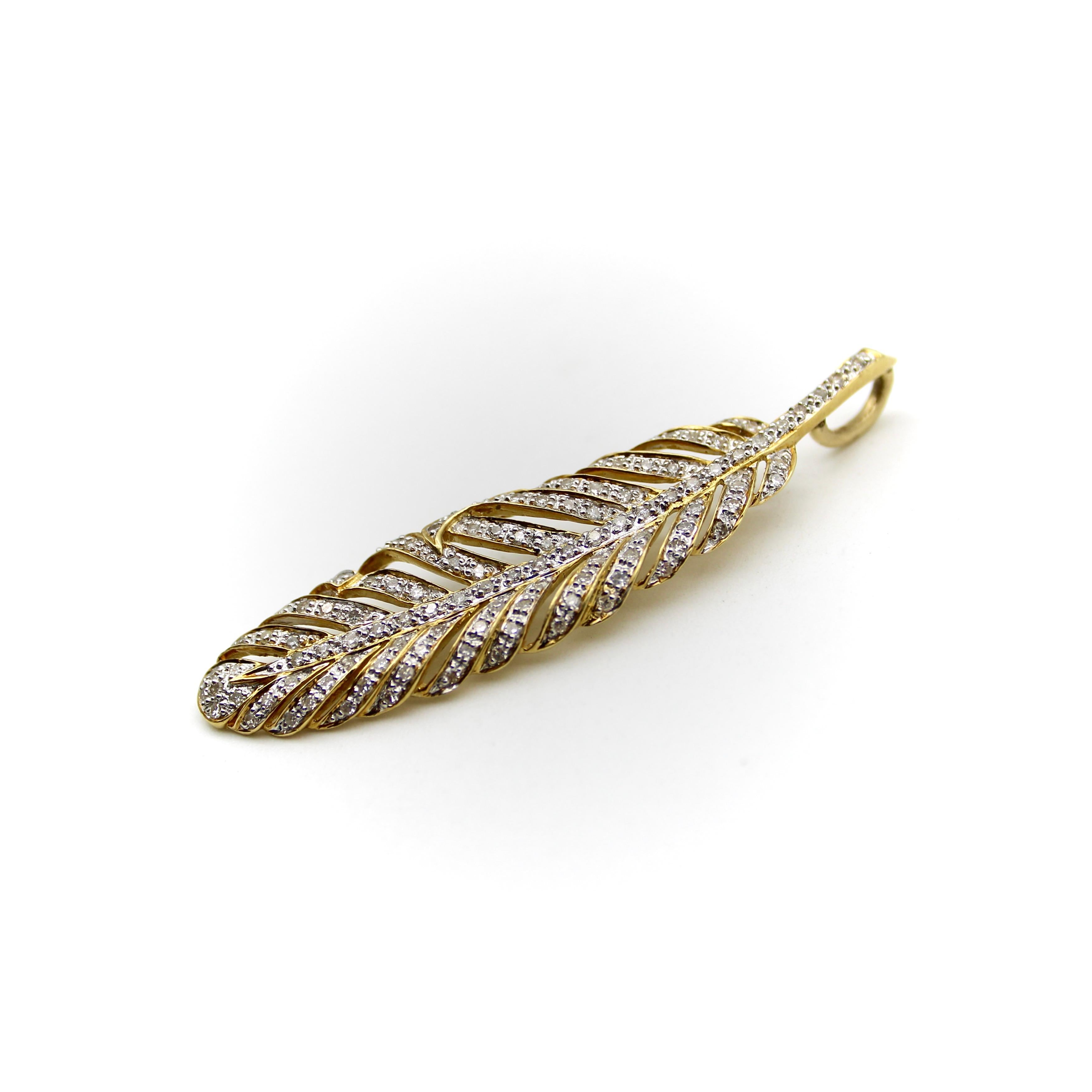 This vintage 18k gold feather pendant is covered in 116 micro-pave diamonds that shimmer in the light. The feather is cut with charming detail, each wisp is separate from the body of the pendant, reticulated to give the feather a light and airy