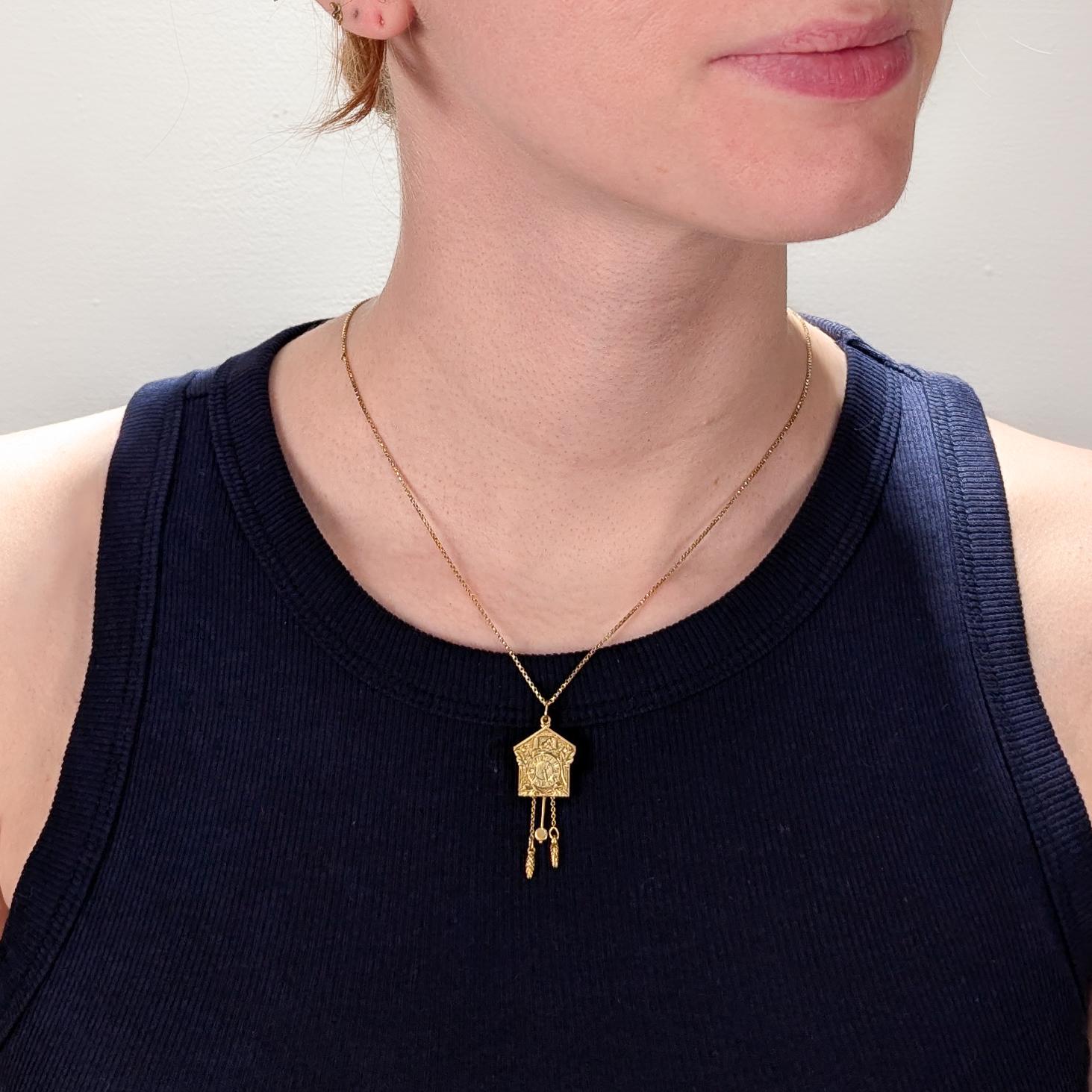A fine vintage figural gold charm.

In 18 karat yellow gold.

In the form of a cuckoo clock - complete with hanging pendulum and weights. The weights are toggled together and move.

With an integral bail and jump ring to the top. 

(Also, doubles