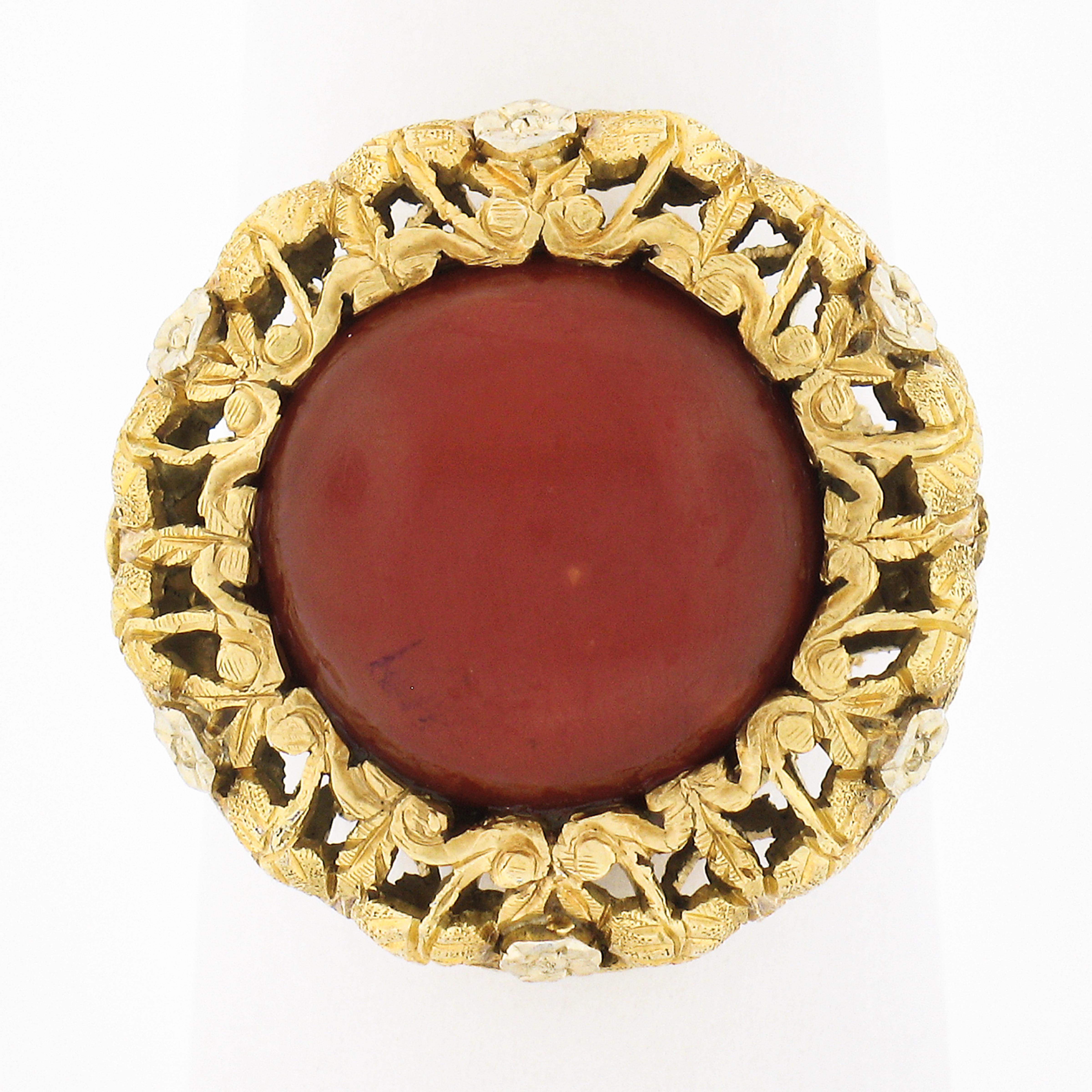 Here we have an absolutely beautiful vintage ring that is very well crafted from solid 18k yellow gold featuring a fine coral stone neatly set at its center. This round cabochon coral is GIA certified, showing a truly gorgeous and intense orangy-red