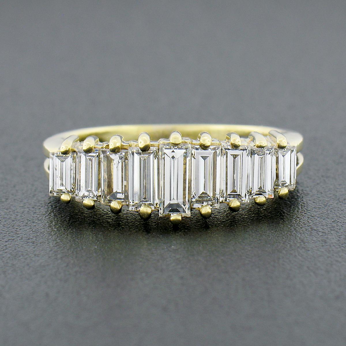 This gorgeous vintage band ring was crafted from solid 18k yellow gold and features 9 straight baguette cut diamonds that are neatly set in a pyramid style across the top. The fine diamonds perfectly graduate in size and height with the largest and