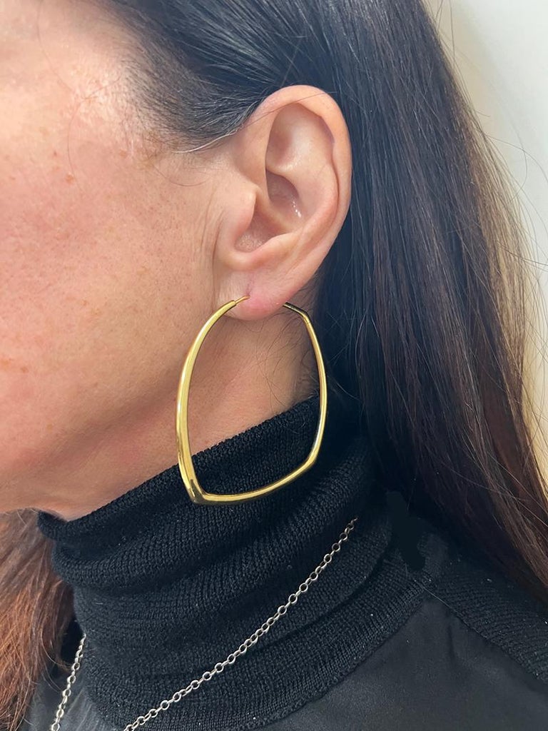 A pair of vintage hoop earrings created in Italy in the 1980s. 
Made of 18 karat yellow gold.
Measurements: 2 3/8” x 2 ¼” x 1/8
