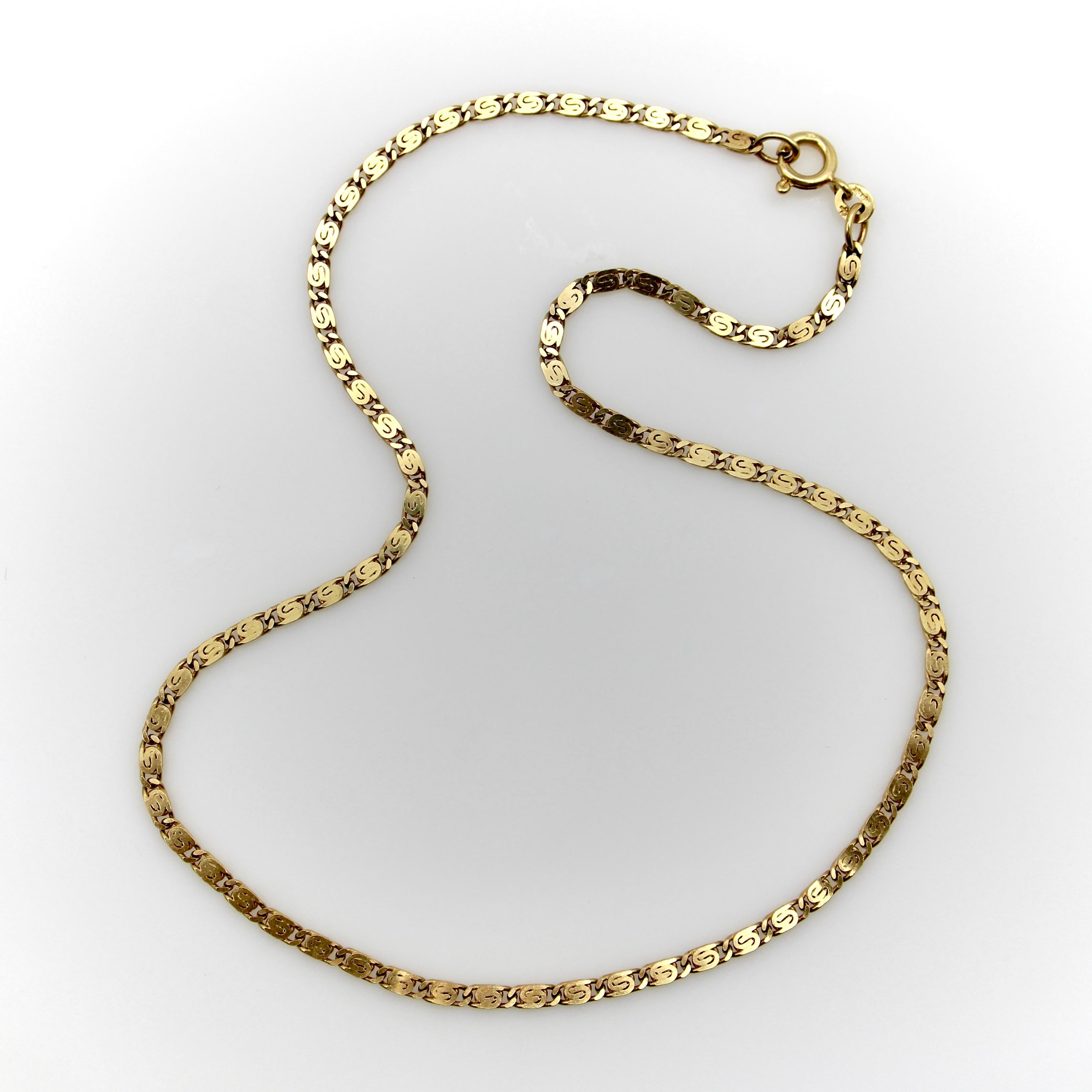Vicenza is known as a quality gold making city, and this beautiful vintage chain is no exception. The 18k gold links are a groovy, flattened version of a Byzantine link with a yin and yang aesthetic. The necklace’s length graces the collarbone— a