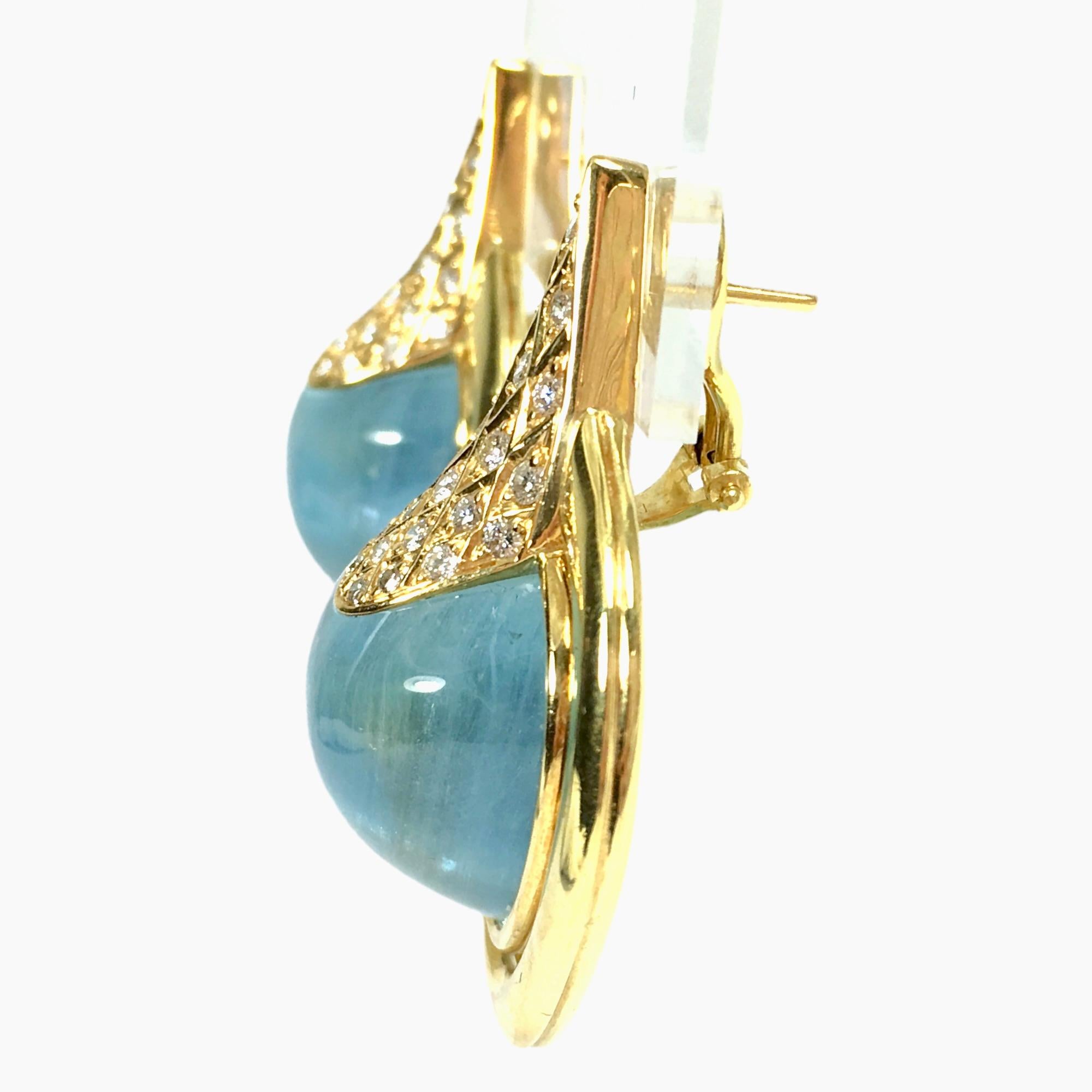Vintage 18K yellow gold one-of-a-kind large aquamarine cabochon and diamond earrings. 
Each earring features an approximately 25ct aquamarine set yellow gold bezel, adorned by a cluster of diamonds. 
Post and omega backs for security.
48 round