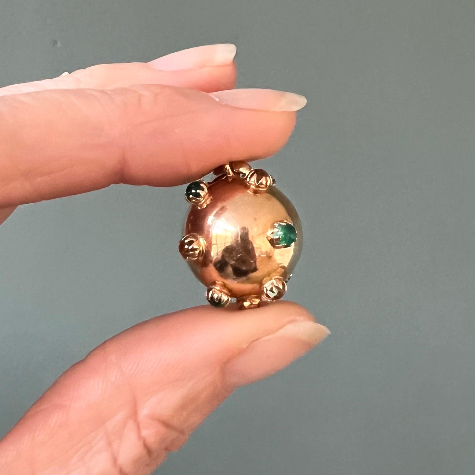 A large yellow gold vintage sputnik charm pendant. This beautiful gold ball pendant is crafted in 18 karat yellow gold and set with multiple studded colored stones.

Charms are wearable memories, it has a symbolic and often a sentimental value. This