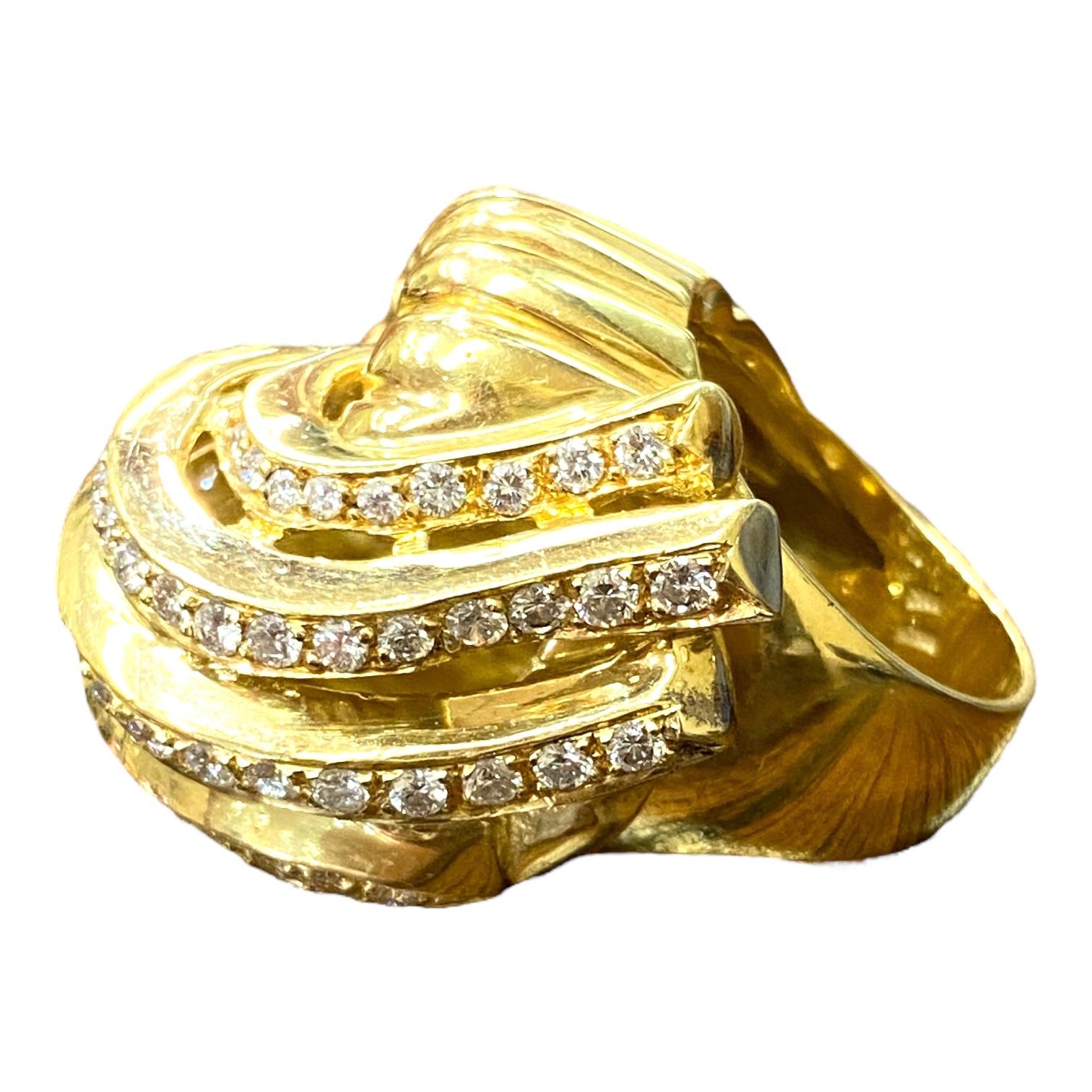 Crafted in 18K yellow gold, the ring features a large scalloped waterfall design set with diamonds.
64 round brilliant cut diamonds: approx. 2.80ctw. Color: G-H, Clarity: VS1-VS2
Measurements:
Front: 27 mm W x 24 mm H x 19 mm D
Band: 6 mm
Size: 6.25