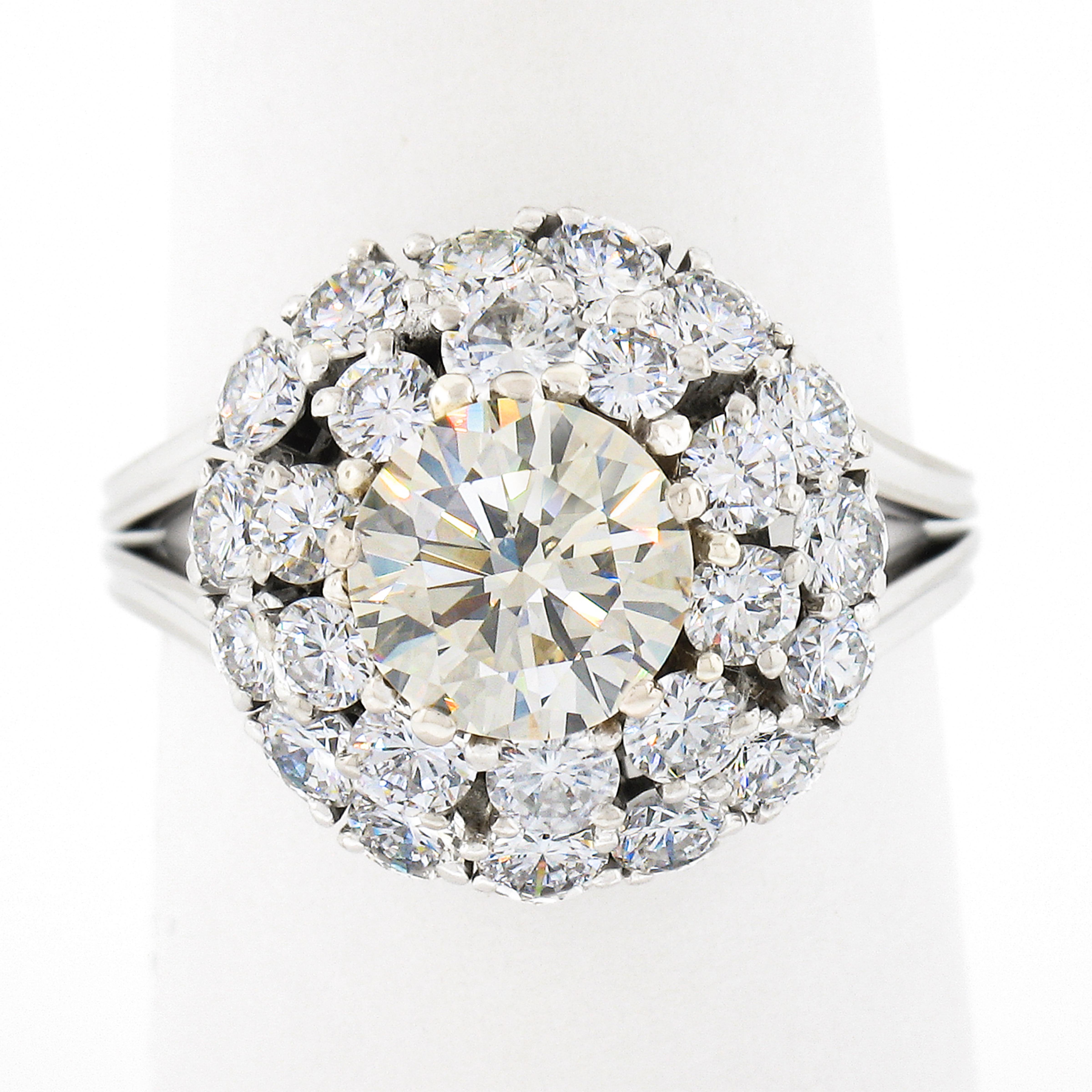 This truly breathtaking and very well made vintage diamond engagement or cocktail ring that was crafted from solid 18k white gold. It features a stunning light yellow diamond neatly prong set at its center and further surrounded by a double, tiered,