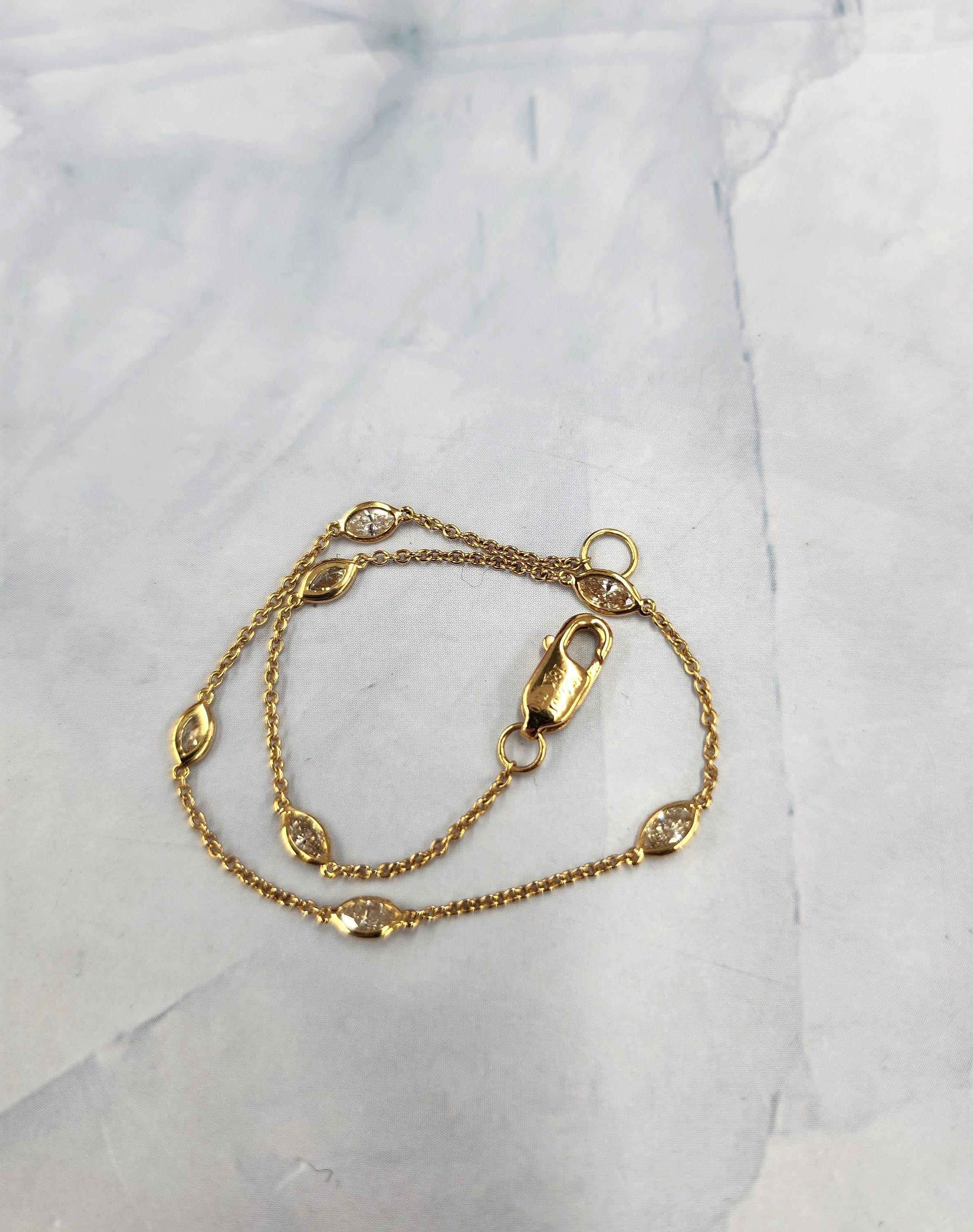 Sweet and chic everyday diamond bracelet.

This bracelet features 7 marquise diamonds bezel set
in diamonds by the yard fashion.

0.51 carats total F/G VS
14k gold stamped on the lobster claw clasp
7 inch length
1.60 grams of 18K gold
