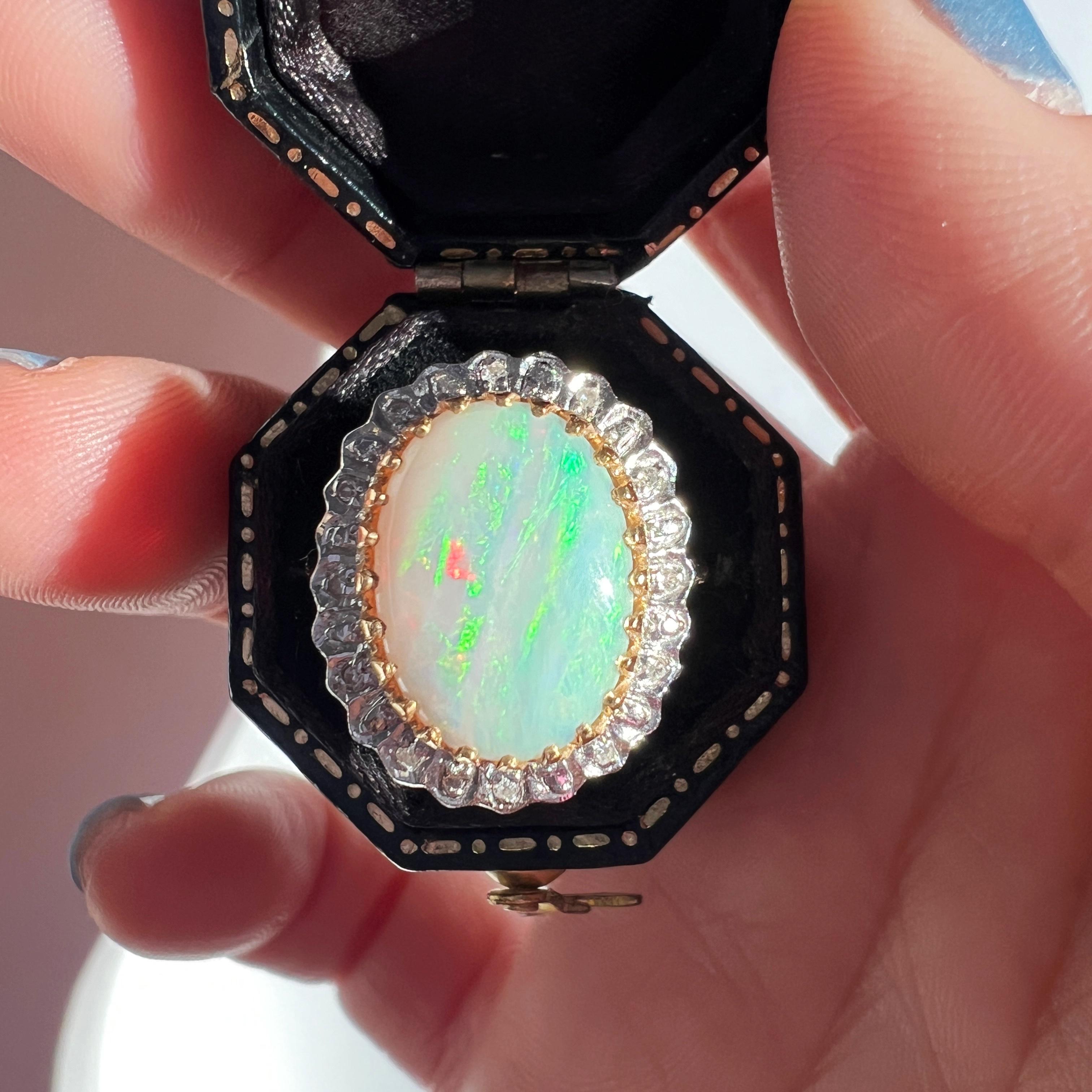 For sale a 18K gold opal diamond cocktail ring. This striking ring features a large, 14mm*11mm white opal, its mesmerizing play of fire exuding a magical allure that makes it truly exceptional.

The opal showcases a dynamic range of colors of