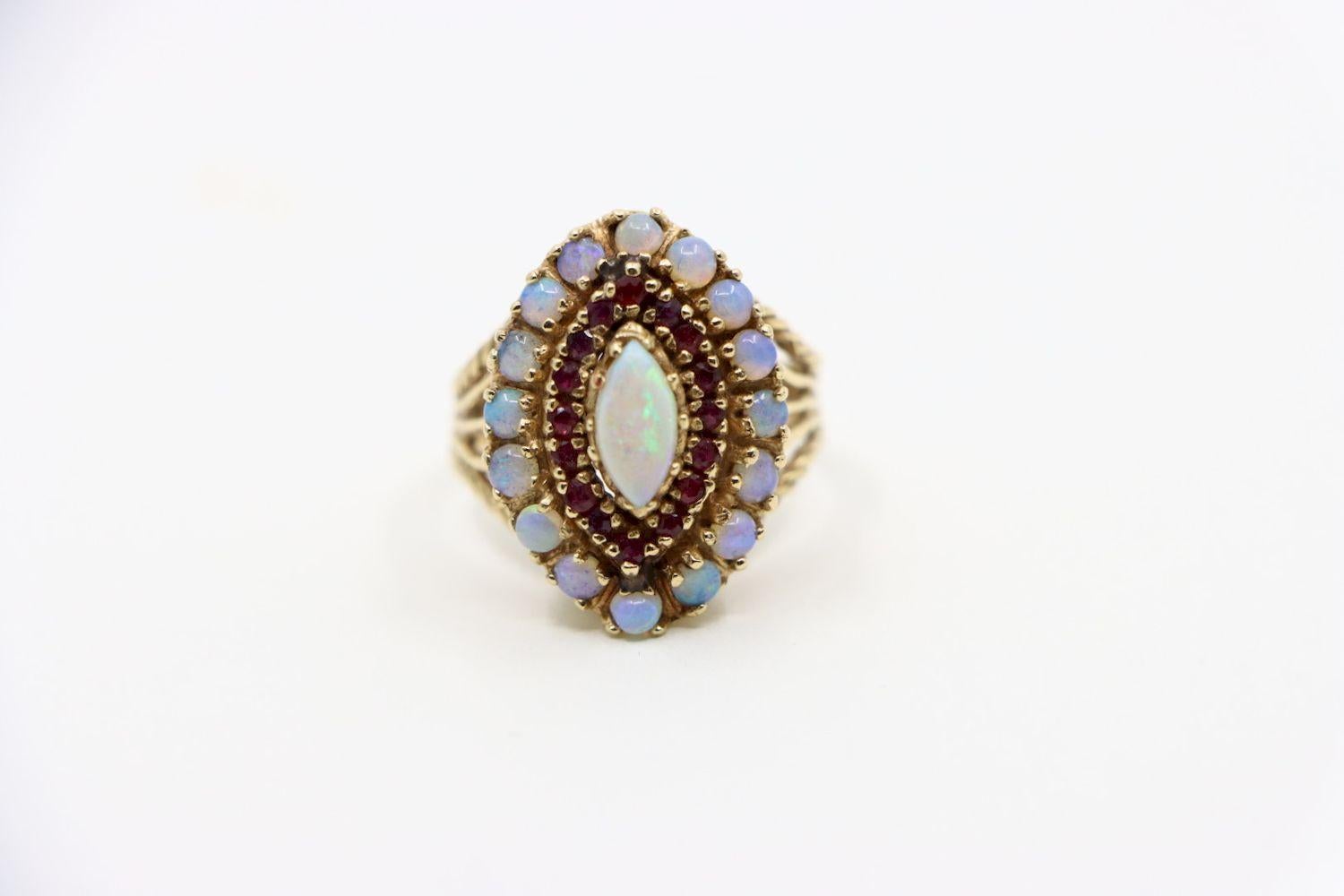 Vintage 18K Gold Opal Ruby Ring

Approximate Dimensions:
10.75 (Ring Size) 
2.7 cm (Width) 
9.61 mm x 4.92 mm - 2.82 mm (Opal) 
1.67 mm (Ruby) 
10.0 grams in weight.