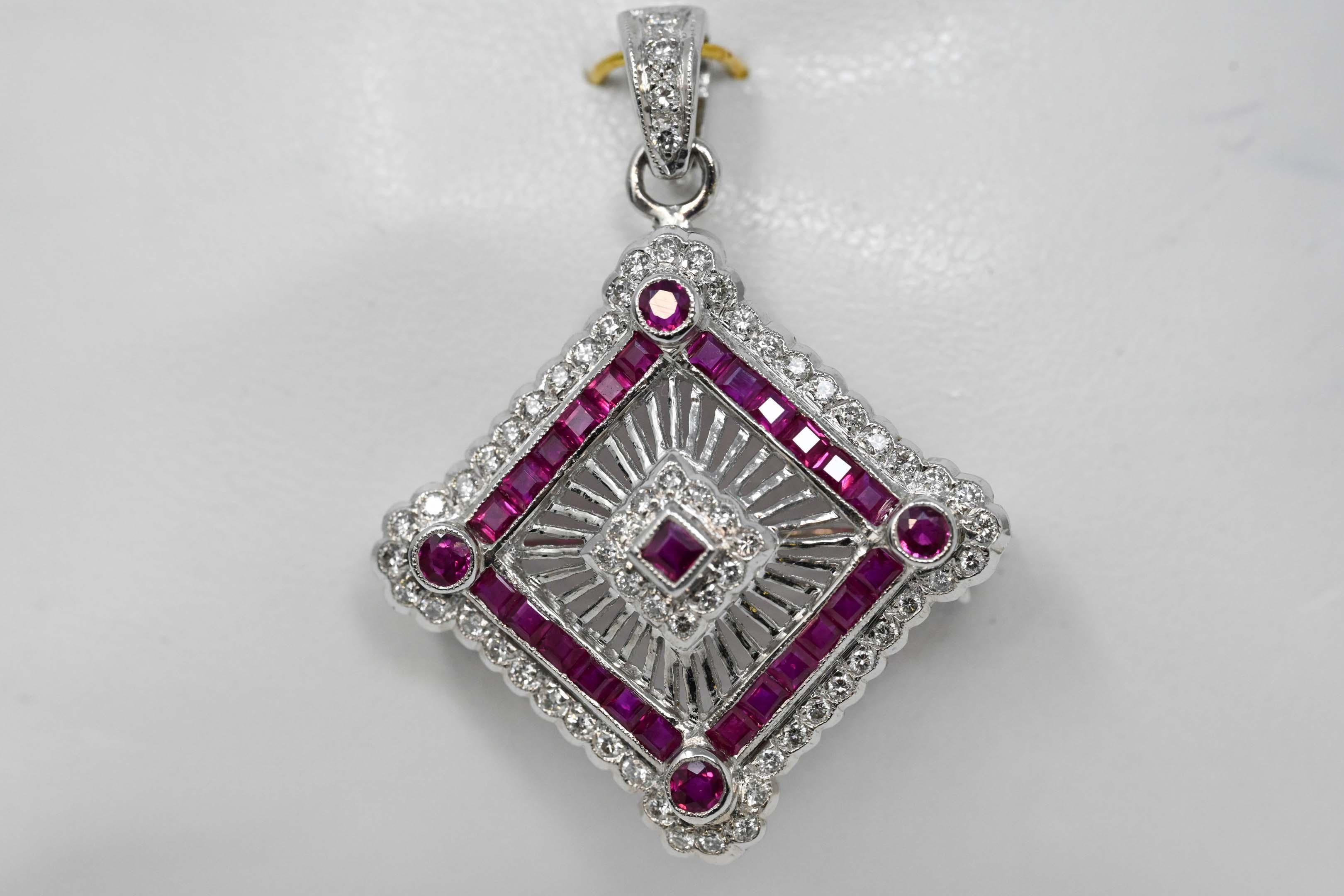 18k white gold pendant set with 64 diamonds full cut VS-GH for a total weight of .65ct, 24 square rubies and 4 round cut. Pendant measures 29mm x 29mm without a loupe. Stamped 750, maker unknown weighs 7.7 grams.
