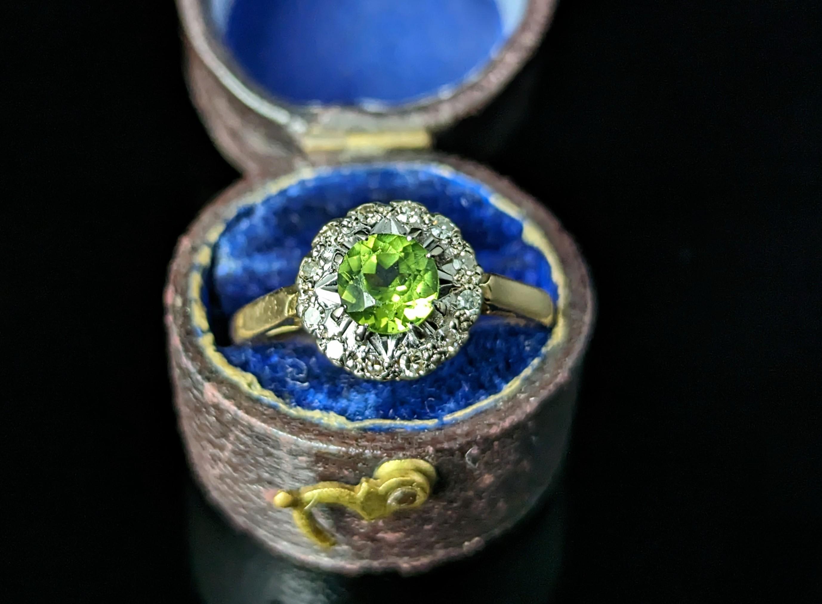 Cheerful and vibrant this vintage Peridot and diamond cluster ring exudes playful luxury.

The vibrant green Peridot set to the centre has the most amazing hue and just can't fail to draw the eye with an approximate 0.75ct weight.

It is set in a