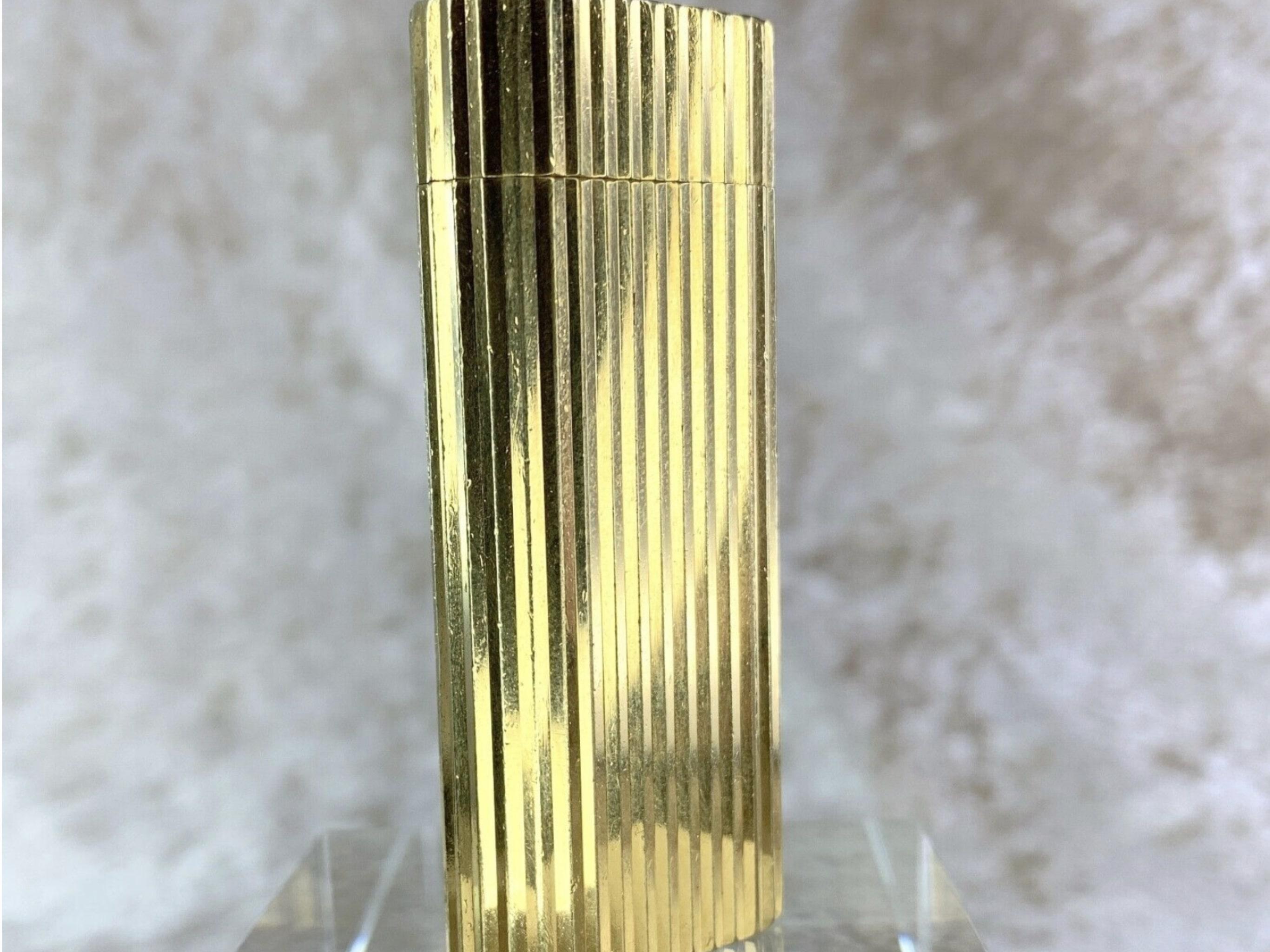Cartier Vintage 
Gordon Cartier Lighter Short Oval 
18K Gold Plated with Diamonds
Original Cartier Case and Certificate
18K Gold Plated Finish and Embellished with Diamonds
Circa 2000
Was overhauled in 2022 at Cartier. 
In fantastic condition 