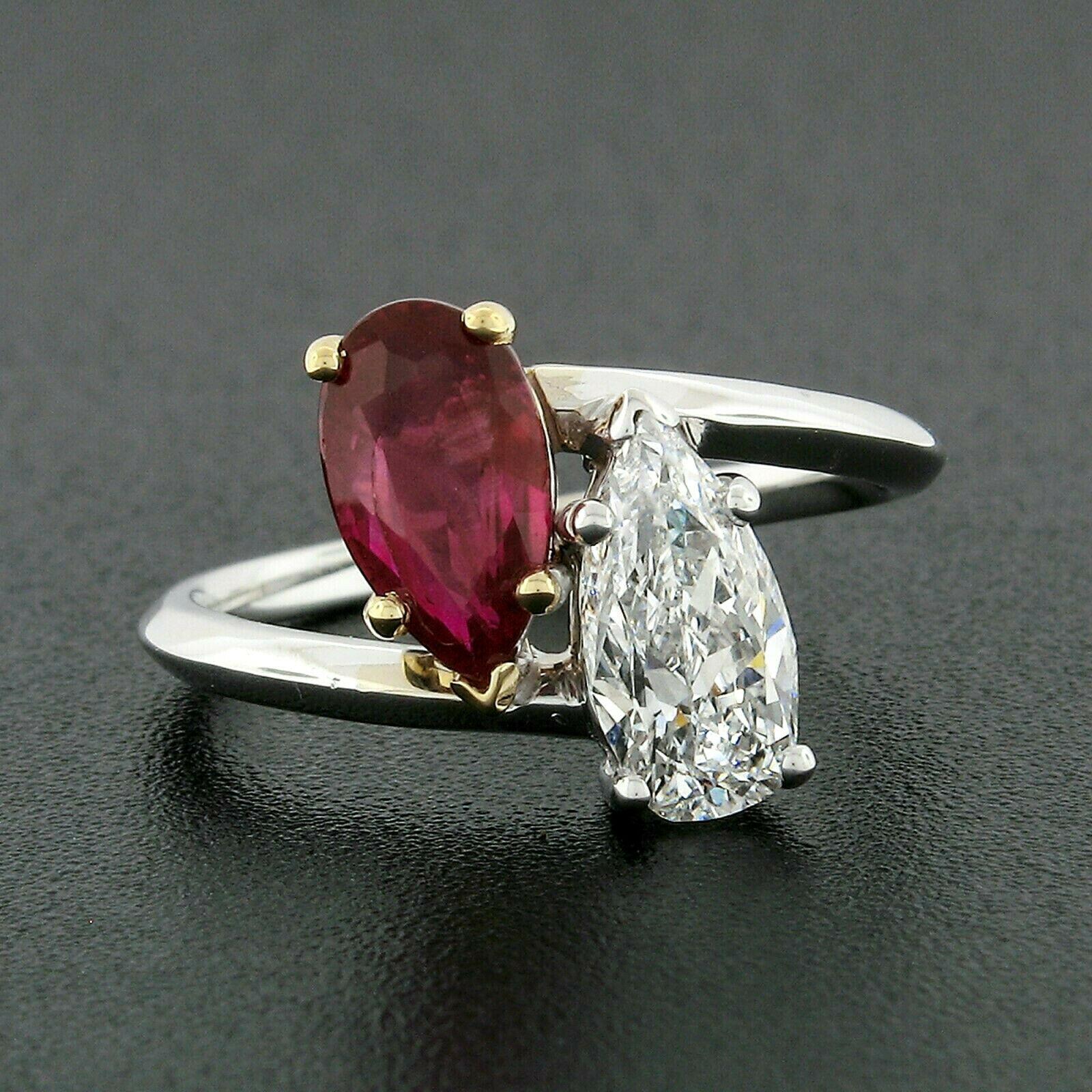 This very fine Moi et Toi bypass ring is solidly and neatly crafted in platinum and 18k yellow gold. It features both GIA certified pear brilliant ruby and old pear cut diamond, prong set at each end of the bypass design. The amazingly ruby stone