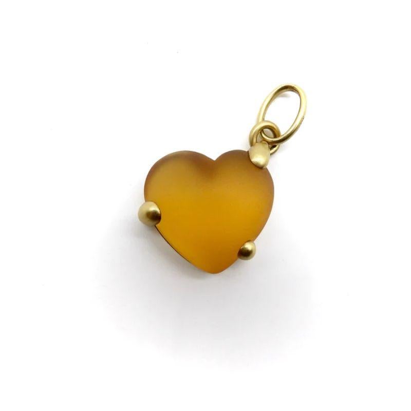 This 18k gold and glass heart radiates with a warm amber hue. Both gold and glass are acid etched, which gives them a matte finish that is luminous and beautiful. The heart is held in an untraditional off-center mount, with an oversized bail, that