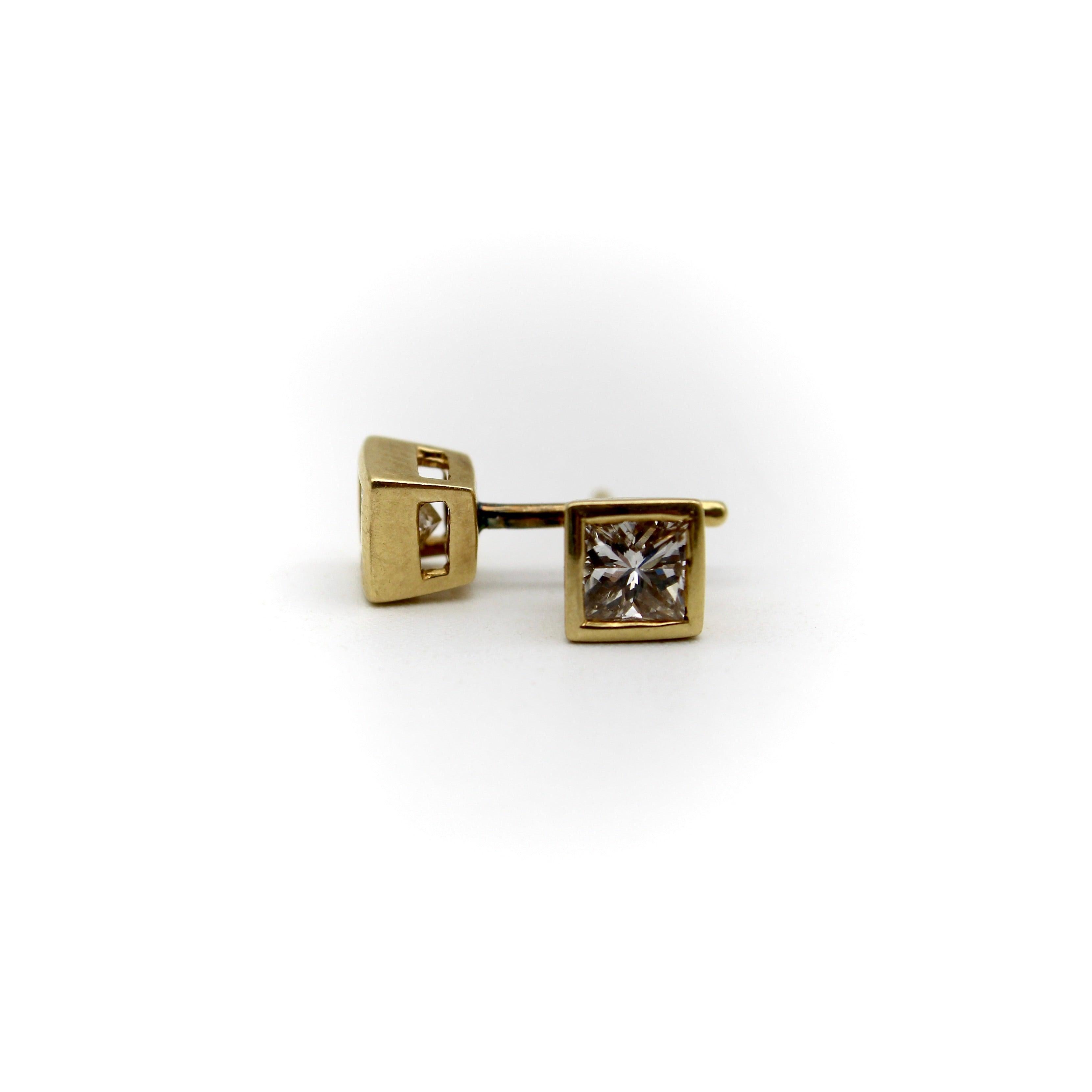 These stunning 18K gold diamond earrings are the perfect blend of sparkle and simplicity. The princess cut diamonds are bezel set in 18k gold squares, complimenting the inner facets. The settings lift up the diamonds so that small cuts along the