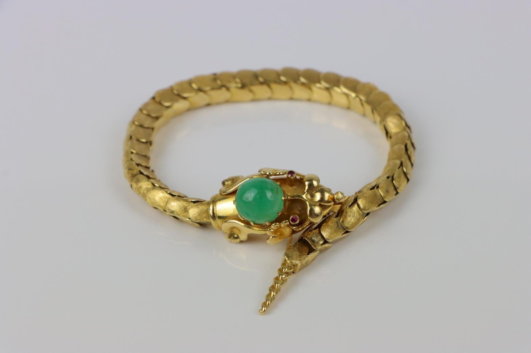 Vintage 18K Gold Reticulated Snake Bracelet 
Circa 1980s
Solid & hand-worked 18K Gold mounted with a high-domed Mottled Green Cabochon and Red cabochon eyes.
Unstamped 

Approximate Dimensions:
22.2 cm (Length) 
0.6 cm (Bracelet Link Width) 
15.875