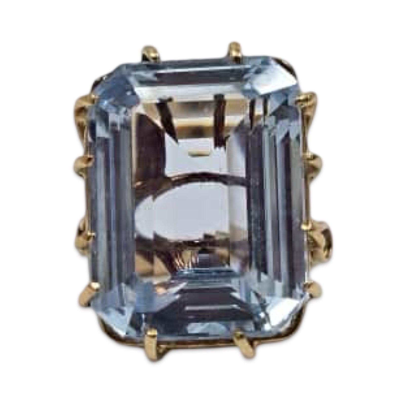 Ein außergewöhnlicher Ring aus 18-karätigem Gelbgold mit einem prächtigen natürlichen Aquamarin von etwa 20 Karat. Der Edelstein im Smaragdschliff misst 19,77 × 14,87 × 8,00 mm und zeigt einen leuchtenden Blauton mit klaren Facetten und